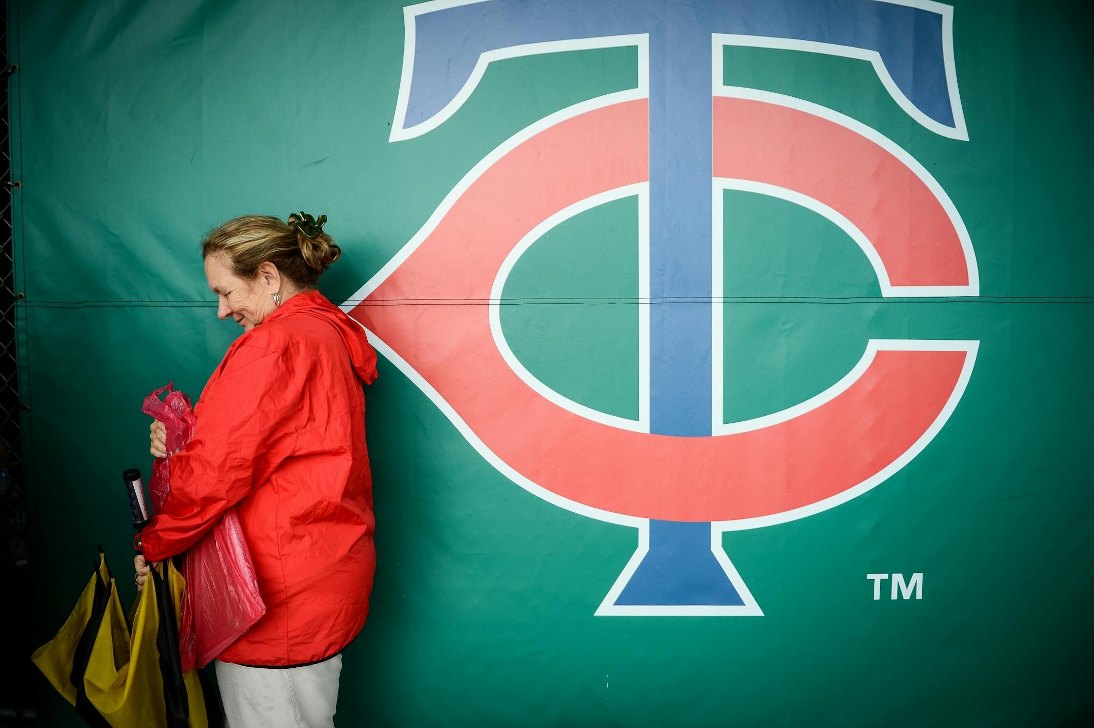 Cindy Johnson, of Fort Myers, watched players practice in the cages Wednesday morning. She was hoping to get a glimpse at Minnesota Twins first baseman Kennys Vargas (19). Rain moved practice into the batting cages and the covered portion of the bullpen.