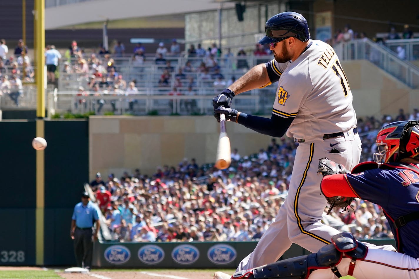 Milwaukee Brewers' Rowdy Tellez (11) swings at an incoming pitch to hit a three-run home run off Minnesota Twins' Griffin Jax in the third inning of a baseball game, Sunday, Aug. 29, 2021, in Minneapolis. (AP Photo/Jim Mone)