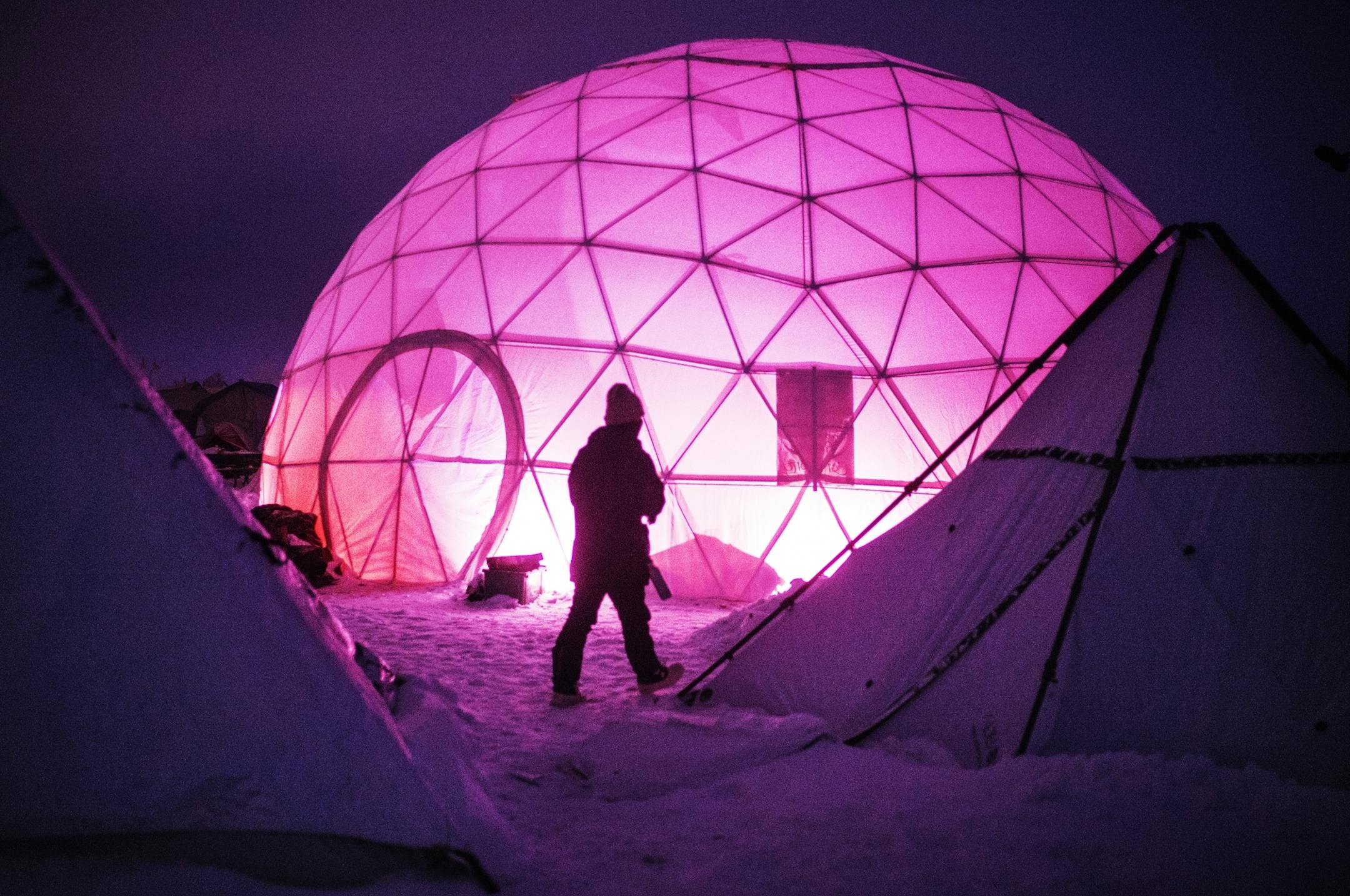 Domed shelters are going up among traditional tipis as places to gather in the cold of the rapidly approaching winter.