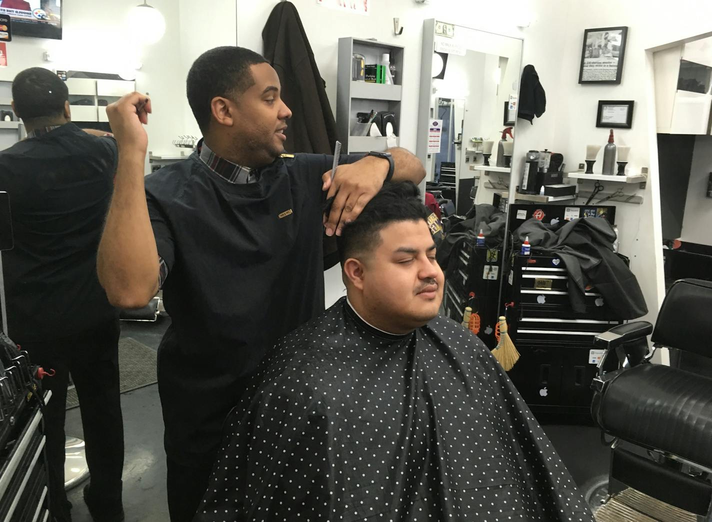 Grooming House owner Daymn Johnson groomed customer Chris Merizalde on a recent January morning. Photo: Neal.St.Anthony@startribune.com