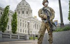 A member of the Minnesota National Guard stands guard by the State Capitol in St. Paul, Minn. Friday, May 29, 2020. Minnesota Gov. Tim Walz announced 
