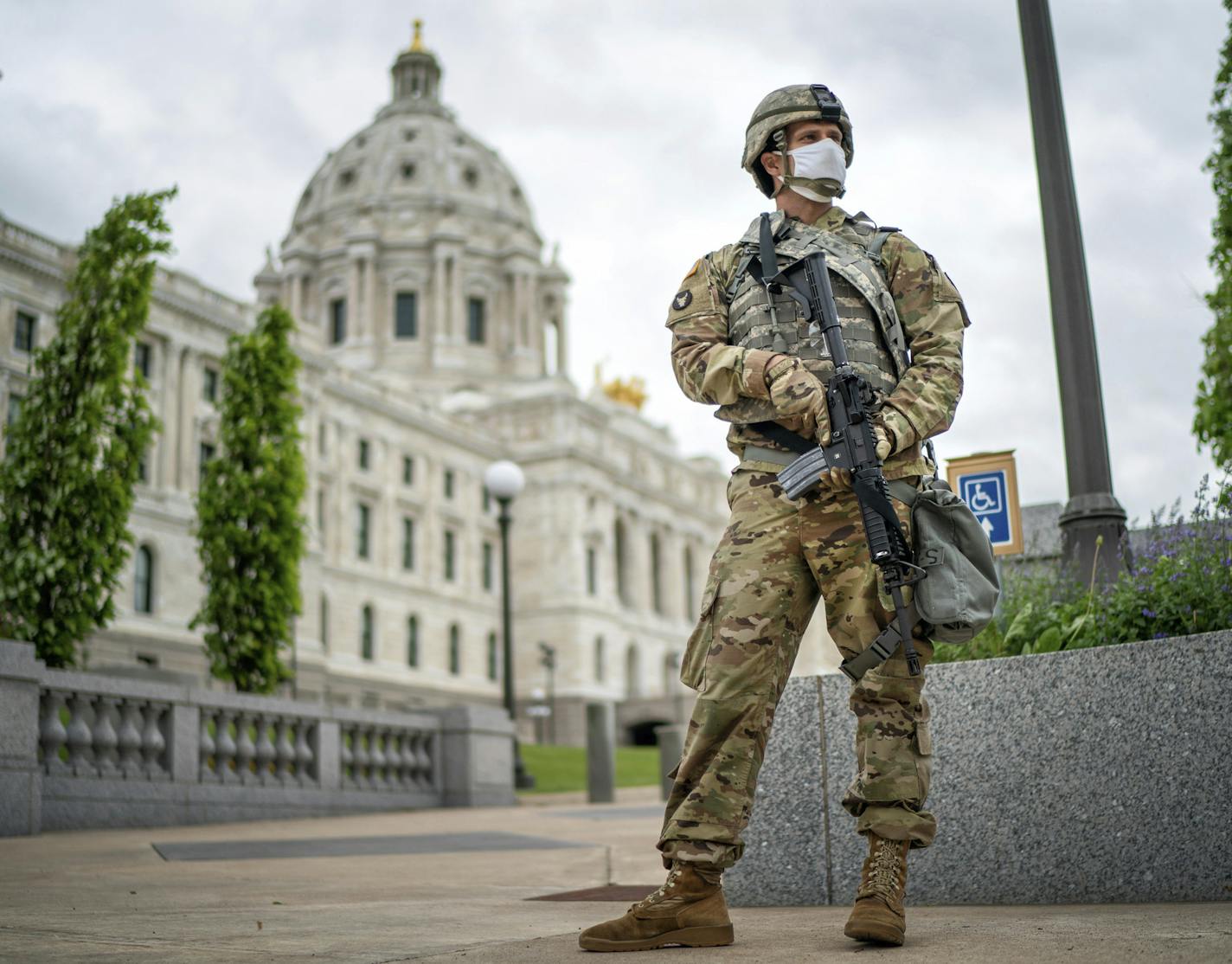 A member of the Minnesota National Guard stands guard by the State Capitol in St. Paul, Minn. Friday, May 29, 2020. Minnesota Gov. Tim Walz announced that he asked the Minnesota National Guard to be responsible for the safety of the State Capitol. (Glen Stubbe/Star Tribune via AP)