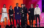 Greta Lee, from left, Pamela Koffler, Teo Yoo, Celine Song, center, John Magaro, Christine Vachon, and David Hinojosa accept the award for best featur