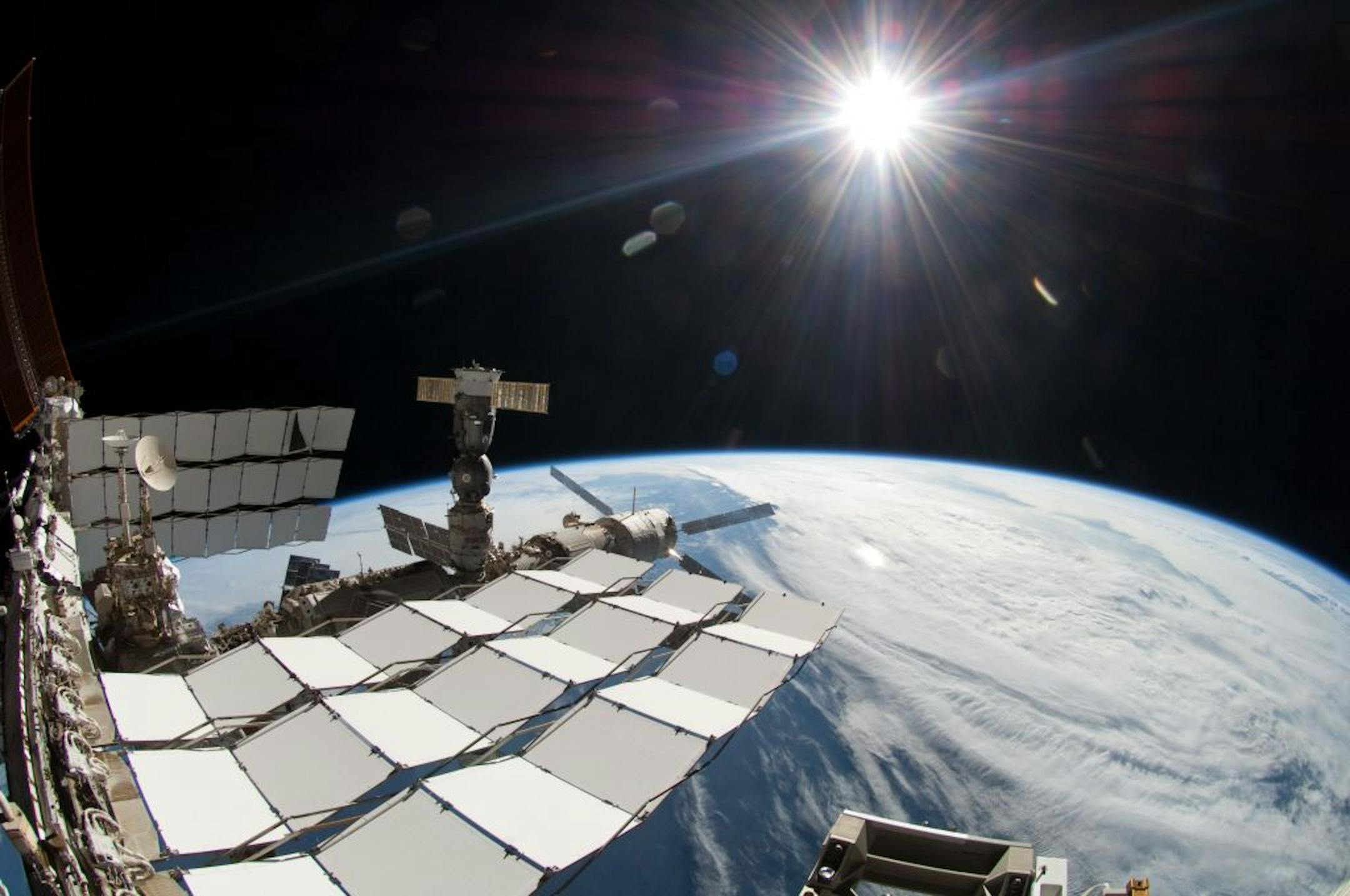 FILE - This Friday May 27, 2011 photo provided by NASA shows the sun, a portion of the International Space Station and Earth's horizon in a photograph made by a spacewalker using a fisheye lens during a space walk.