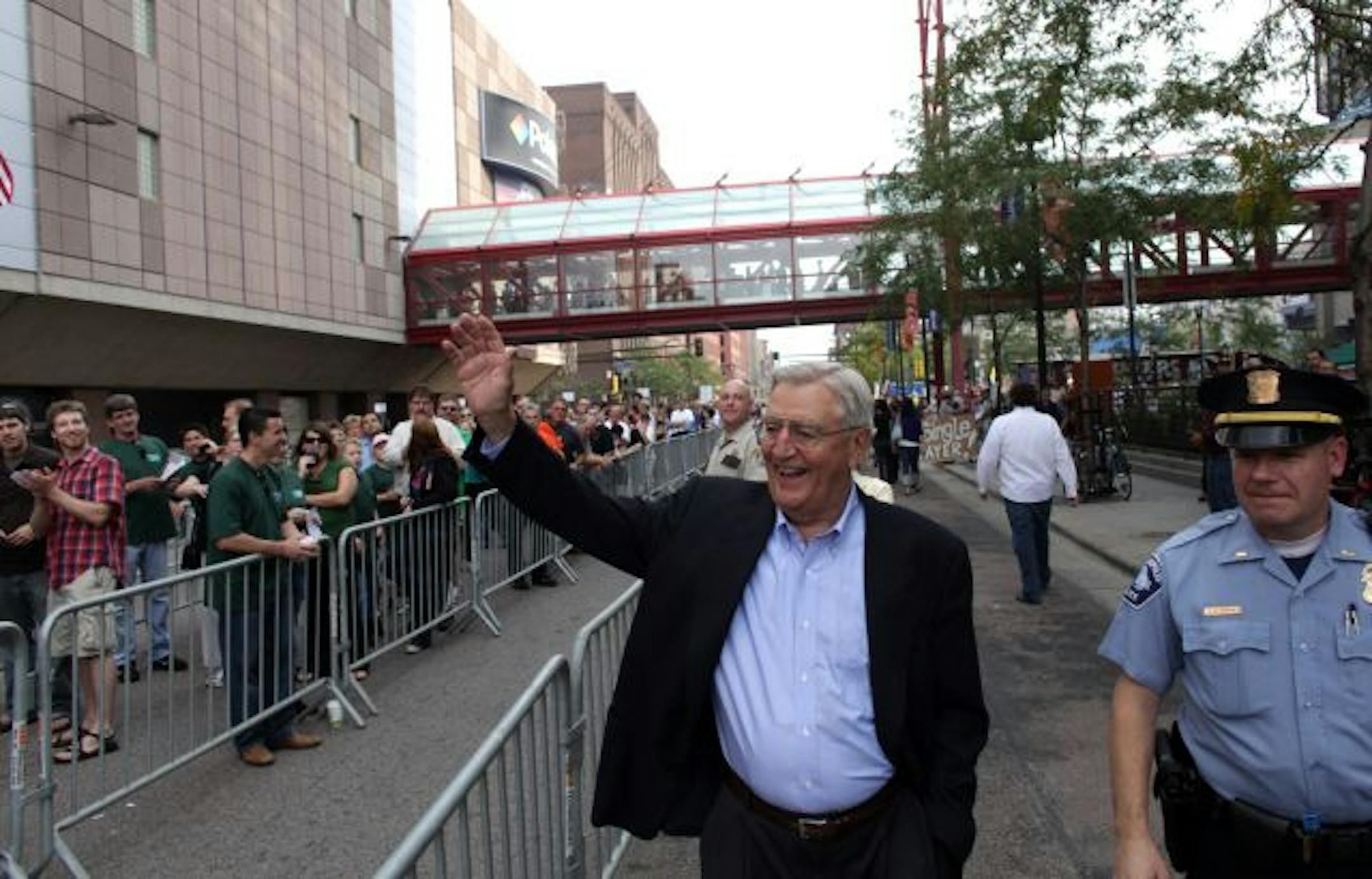 Former Vice President Walter Mondale waved to people standing in line as they clapped for him before entering the Target Center where President Obama was going to speak about health care.