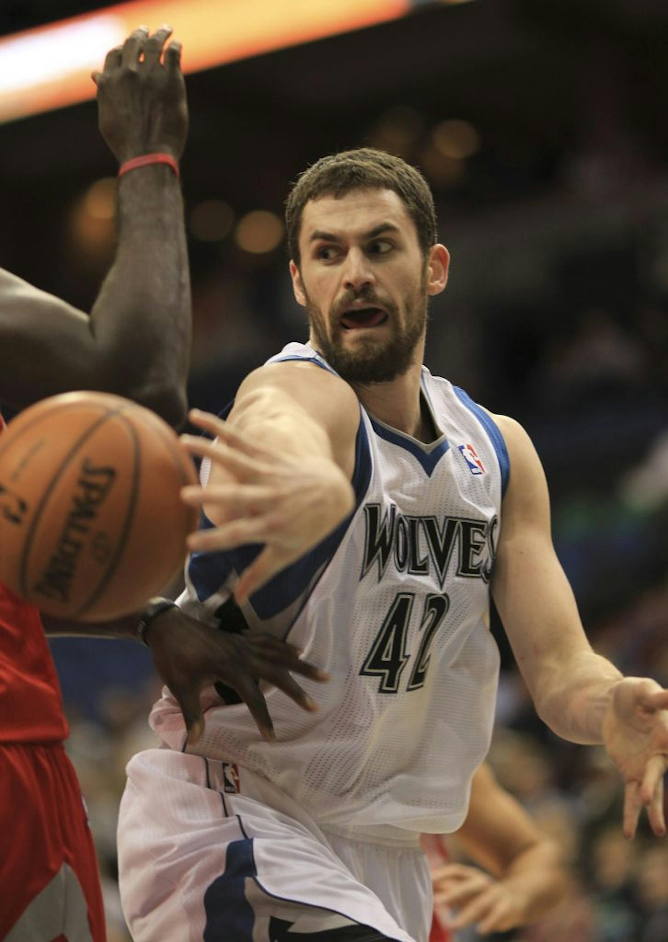 Kevin Love passed off under the net in the first quarter against the Rockets on Monday night. The Timberwolves lost 107-92.