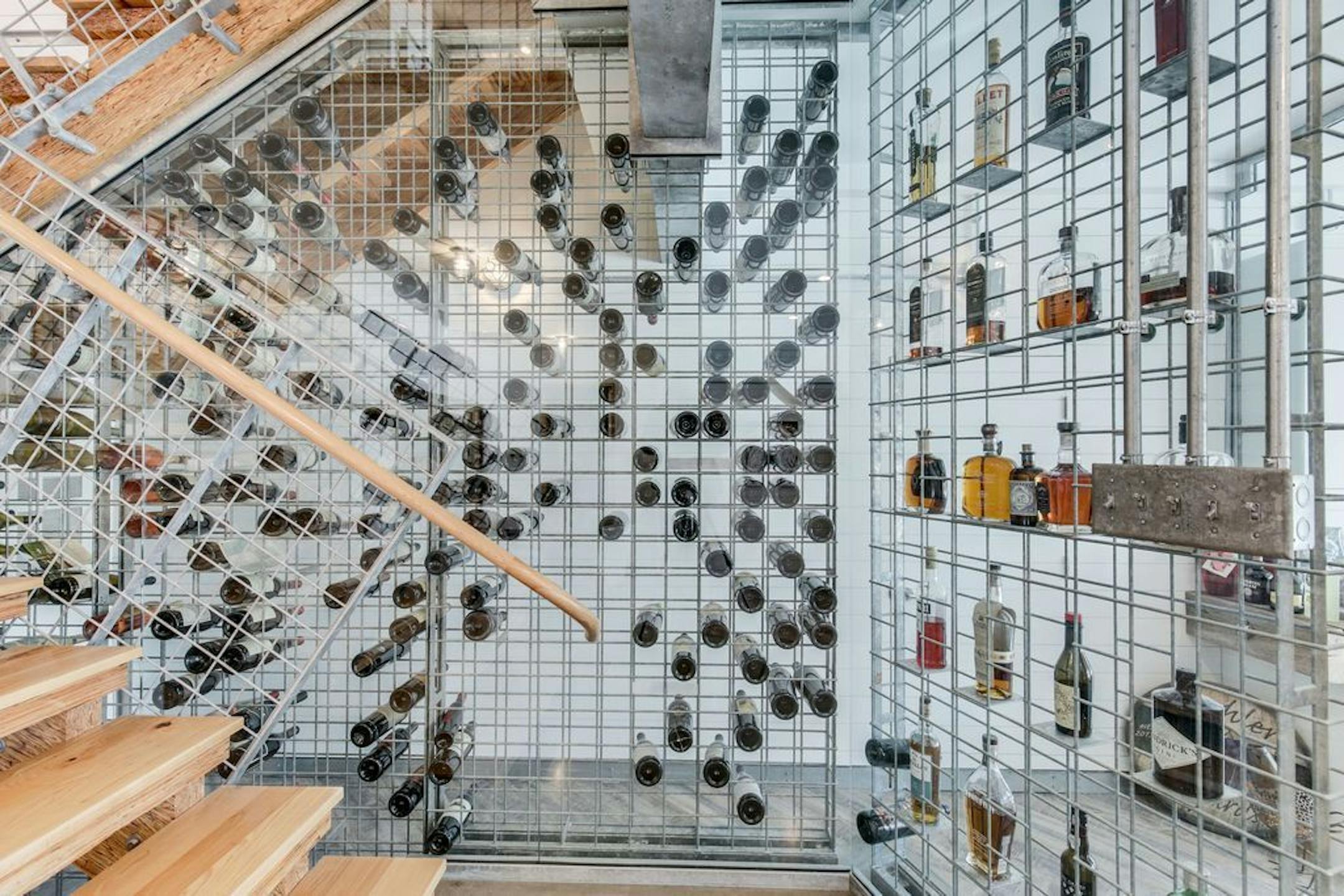 The wine is stored and displayed in metal racks.