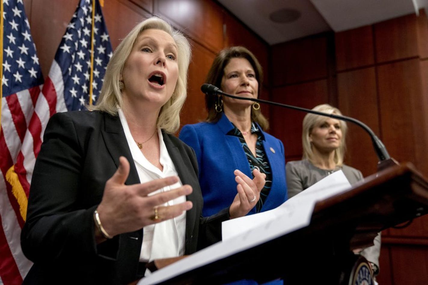 From left, Sen. Kirsten Gillibrand, D-N.Y., accompanied by Rep. Cheri Bustos, D-Ill., and former Fox News host Gretchen Carlson, speaks at a news conference where she and other members of congress introduce legislation to curb sexual harassment in the workplace, on Capitol Hill, Wednesday, Dec. 6, 2017, in Washington.