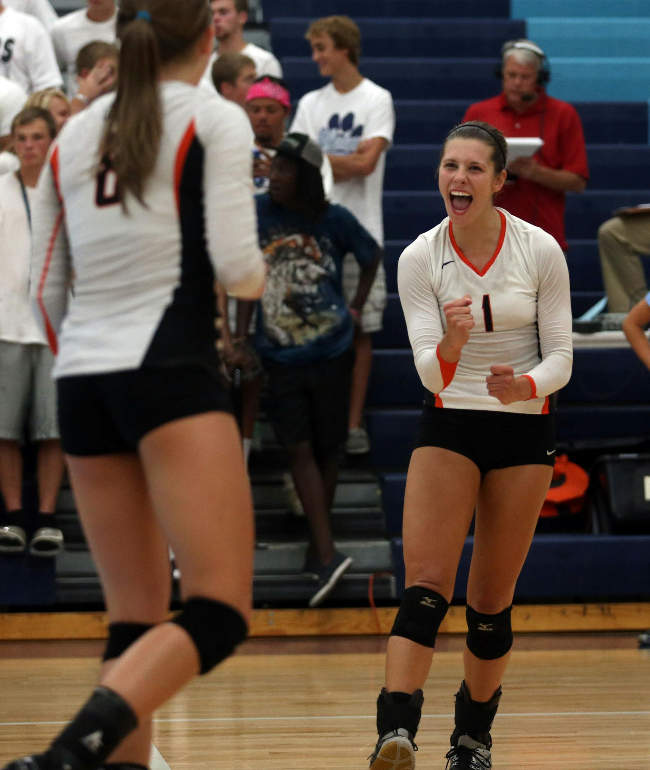 Osseo's Megan Pekarek celebrated with her teammates after a scoring a point during their game with Blaine High School in Blaine Tuesday September 10, 2013. ] (KYNDELL HARKNESS/STAR TRIBUNE) kyndell.harkness@startribune.com