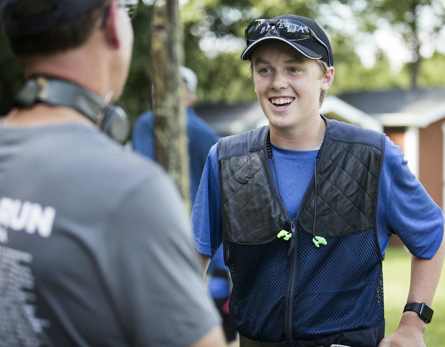 Nathan Ziemer, right, 15, of the Wayzata High School Trap Team, talks with Plymouth Police officer Paul Johnson before they begin shooting. ] (Leila Navidi/Star Tribune) leila.navidi@startribune.com BACKGROUND INFORMATION: The Wayzata High School Trap Team paired up with the Plymouth Police on Tuesday, August 9, 2016 for some friendly trap shooting at the Plymouth Gun Club. In Minnesota, trap shooting is the fastest growing high school sport, with nearly 9,000 students participating in clay targ