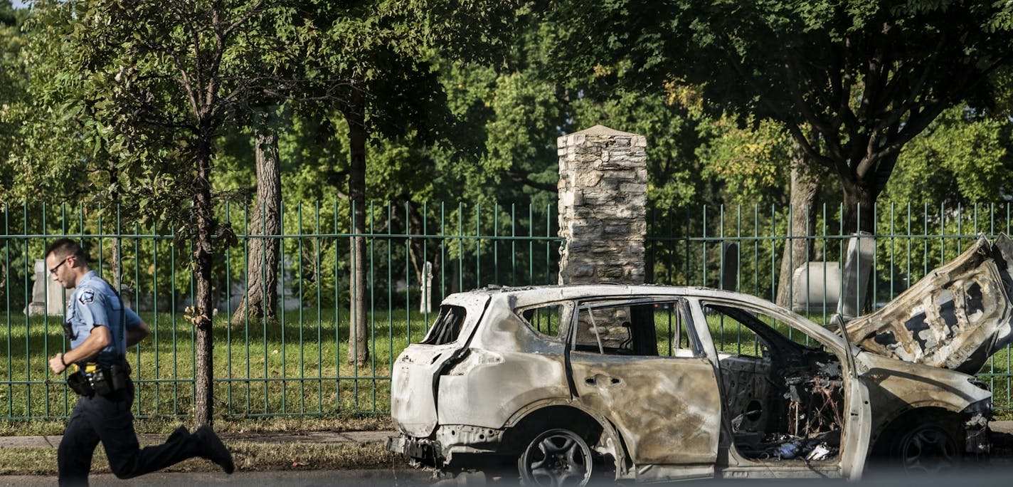 A driver fleeing police after a carjacking on Monday, Sept. 30, hit a bakery, rammed a squad car and then jumped a curb and burst into flames, Minneapolis police said.