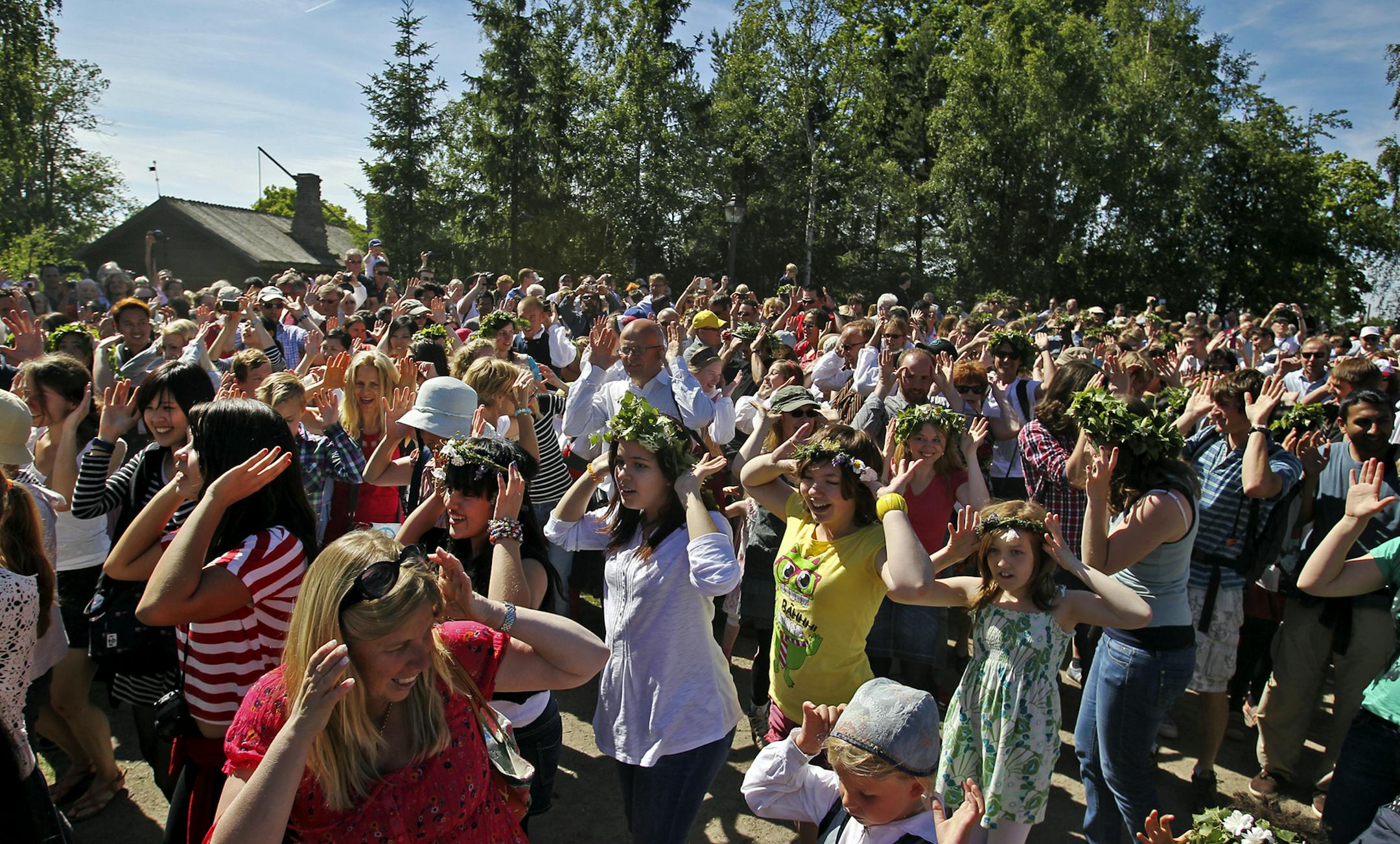 A throng of celebrants dance to the 'frog dance' song during the Midsummer celebration at Skansen Friday, June 22, 2012, in Stockholm, Sweden.](DAVID JOLES/STARTRIBUNE) djoles@startribune.com Travel story on Sweden.]