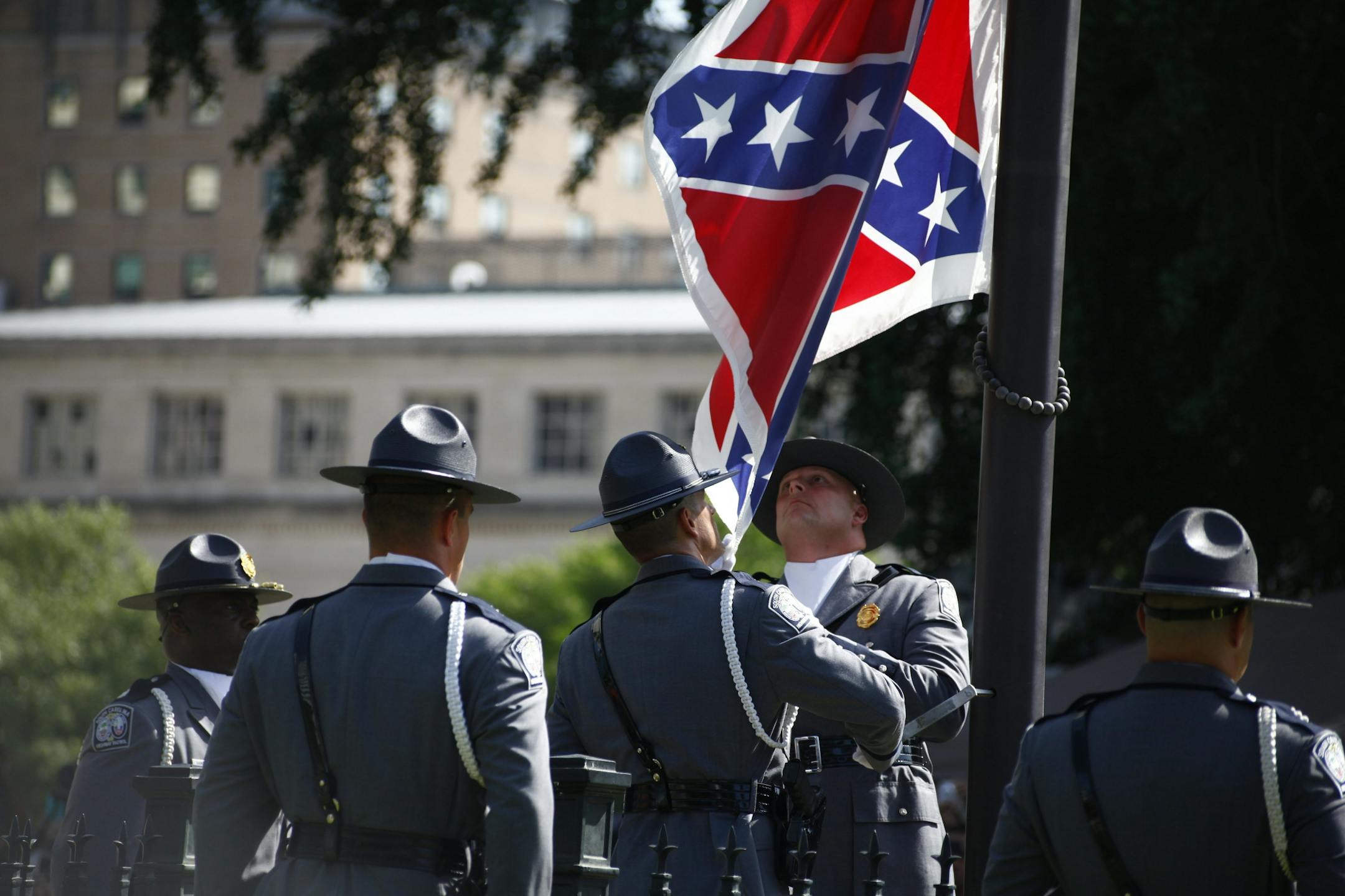 Members of the South Carolina State Police remove the Confederate battle flag from the grounds of the State House in Columbia, S.C., the morning of July 10, 2015. Closing a chapter on a symbol of the Deep South and its history of resistance and racial animus, the state on Friday lowered the flag from where it had flown for more than 50 years.