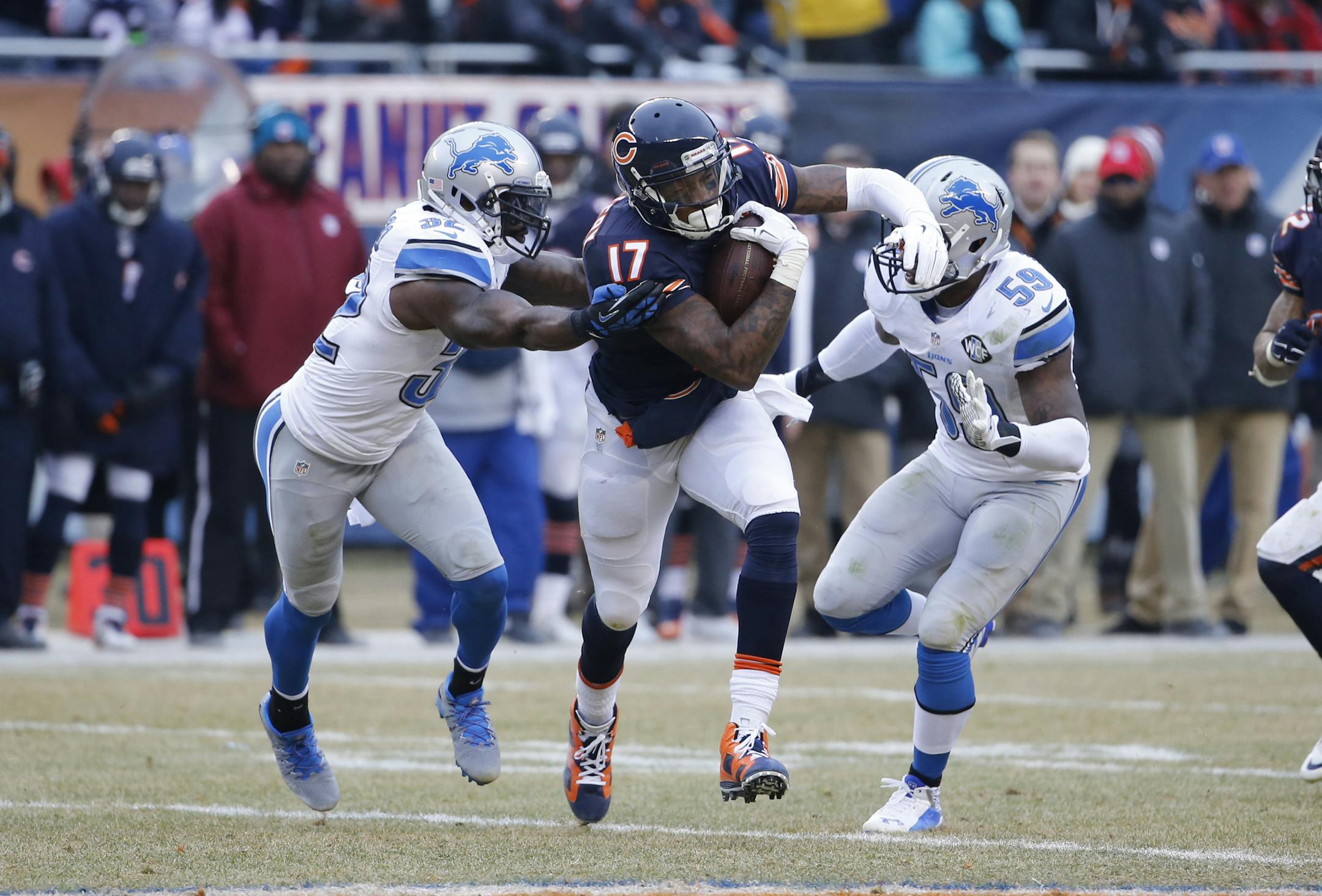 Chicago Bears wide receiver Alshon Jeffery (17) carries the ball against Detroit Lions safety James Ihedigbo (32) and linebacker Tahir Whitehead (59) in the first half of an NFL football game Sunday, Dec. 21, 2014, in Chicago.