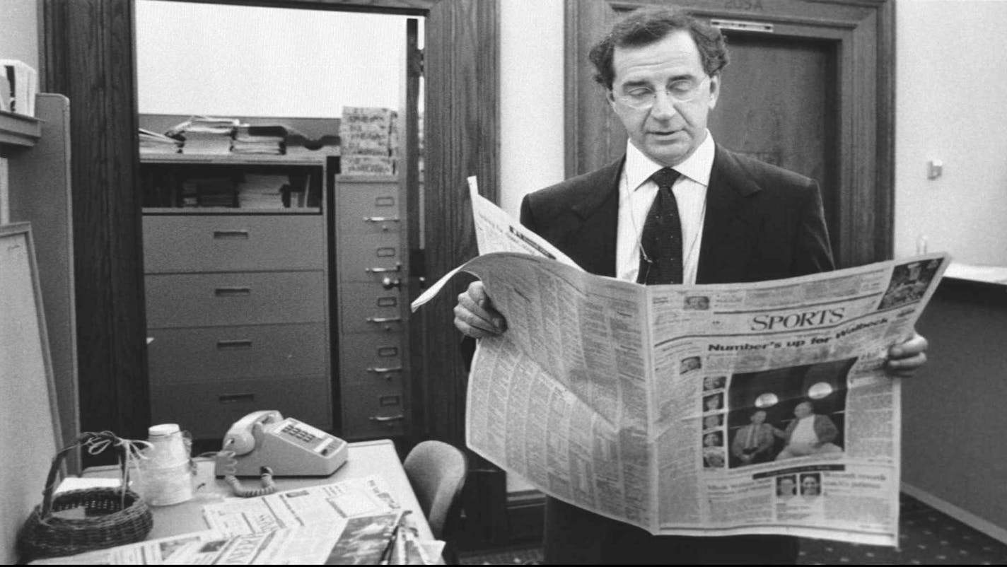 Richard Burke, prospective buyer of the Winnipeg Jets hockey franchise, reads the sports page Tuesday, May 16, 1995, at the State Capitol in St. Paul, Minn. Burke met with legislators to describe his bid for the team and the timeline for legislative approval of a state-aid package. (AP Photo/Tom Olmscheid)