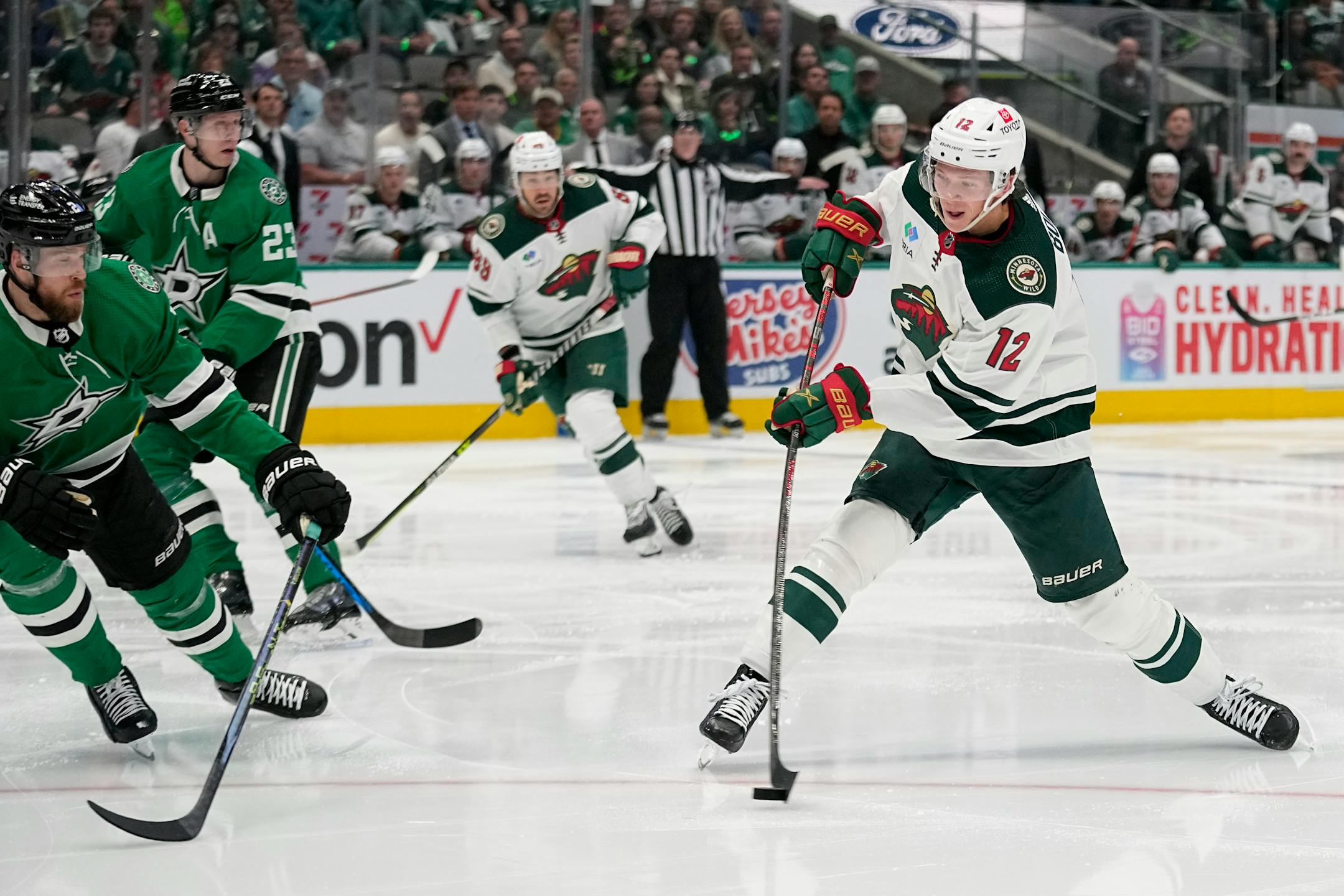 Minnesota Wild left wing Matt Boldy, right, takes a shot as Dallas Stars' Jani Hakanpa, left, defends in the second period of Game 1.