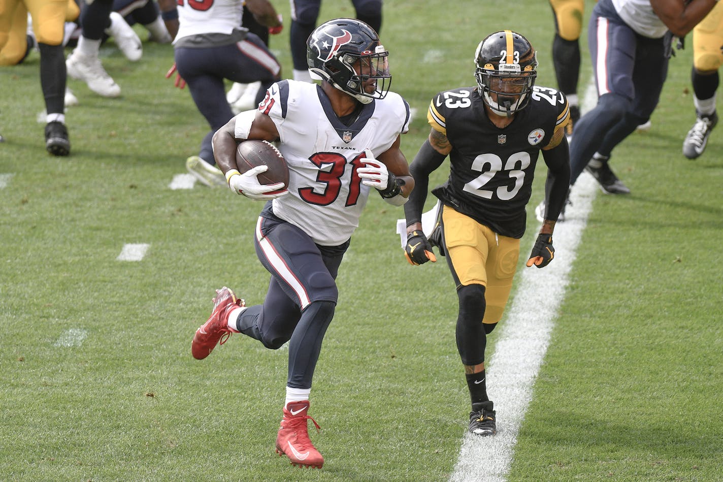 Houston Texans running back David Johnson (31) gets past Pittsburgh Steelers cornerback Joe Haden (23) to score a touchdown during the first half of an NFL football game, Sunday, Sept. 27, 2020, in Pittsburgh. (AP Photo/Don Wright)