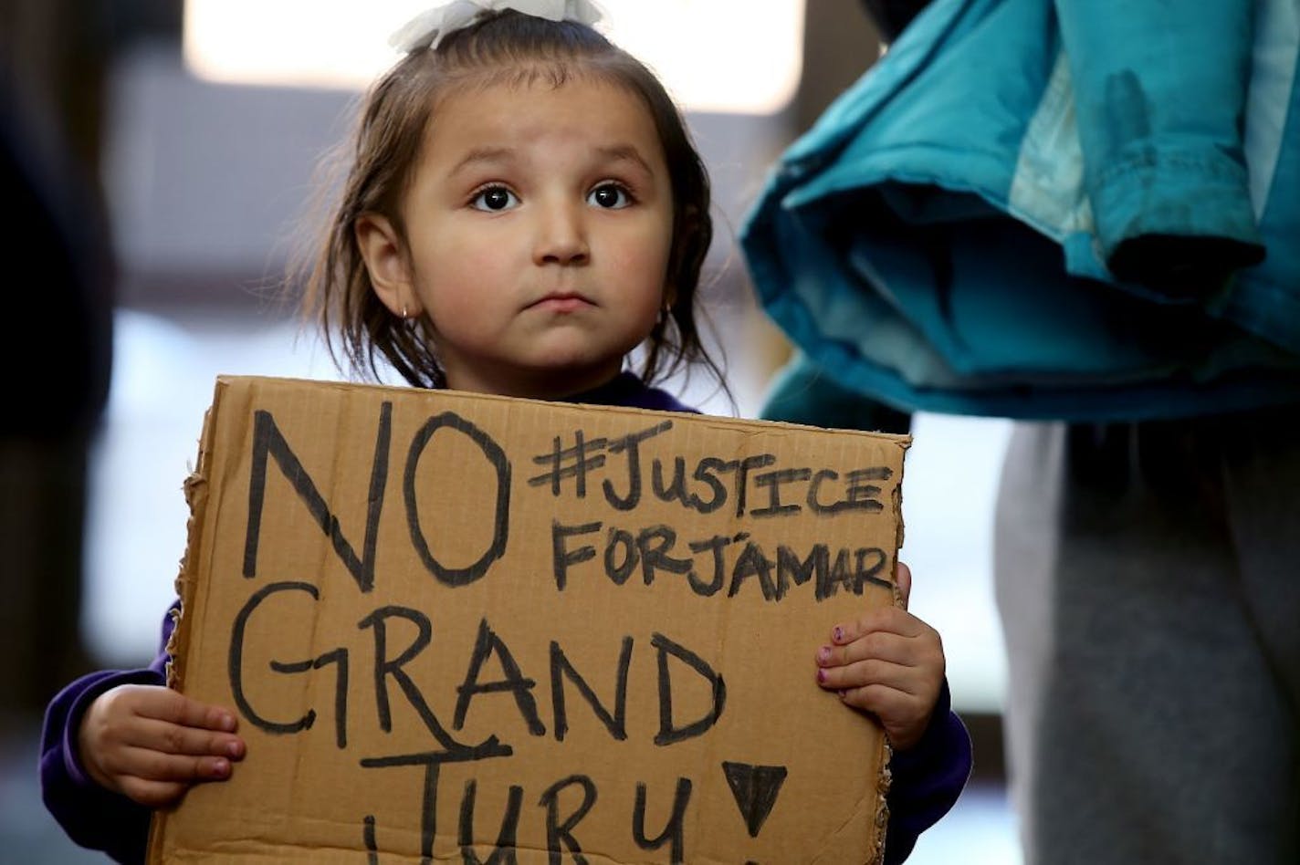 Aryn Seymour, 3, joined her mother Alexandria Lane and about 40 others for a "Freeman Friday," at the Hennepin County Government Center, Friday, Feb. 12, 2016 in Minneapolis, Minn. Members of the Twin Cities Coalition 4 Justice 4 Jamar Clark rallied at the Hennepin County Government Center Friday and dropped by Freeman's office. They want justice for 24-year-old Jamar Clark, who died in a confrontation with Minneapolis police on Nov. 15.