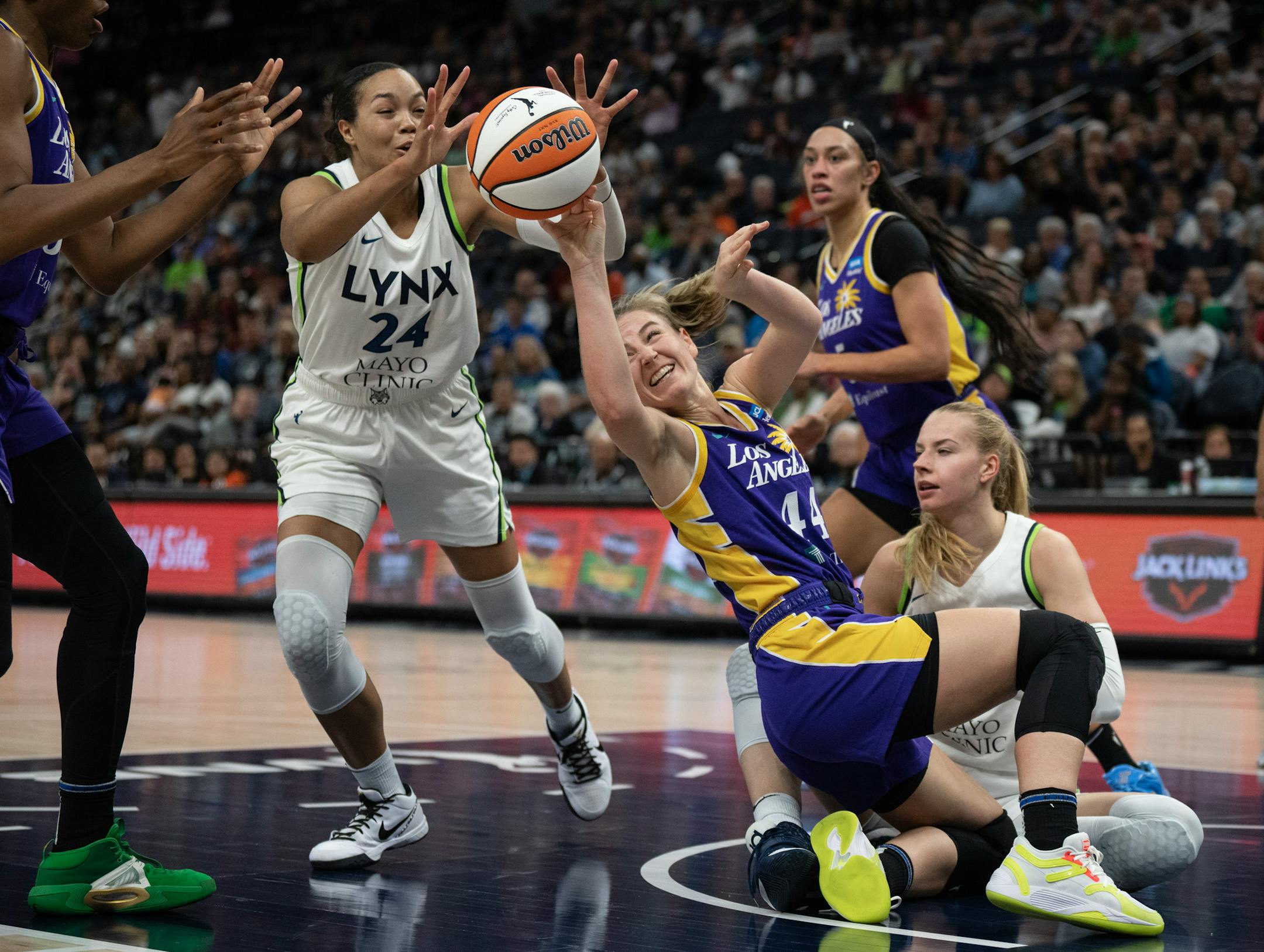 Minnesota Lynx forward Napheesa Collier (24) reached for the ball as the Los Angeles Sparks' Karlie Samuelson lost control in the second quarter Sunday.