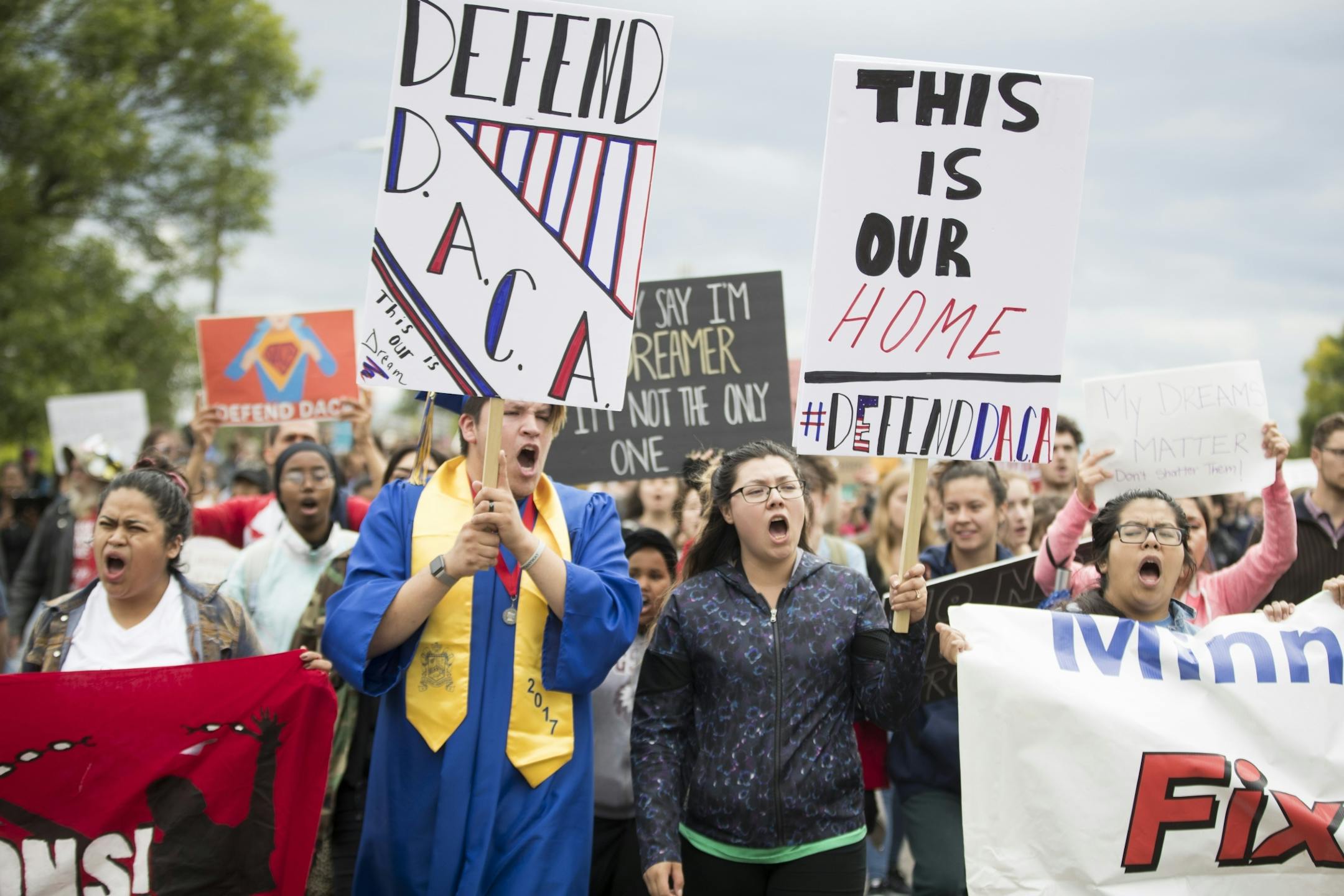 Daniel Sosa, wearing his graduation robe, who attends college in Mankato and and has a DJ business and Johanna Evans, 24, who is a preschool teacher, led a march in protest of the announcement that Trump is rescinding DACA in Minneapolis, Minn. on Tuesday September 5, 2017.on Tuesday, September 5, 2017, Minneapolis, Minn. Both are DACA recipients.