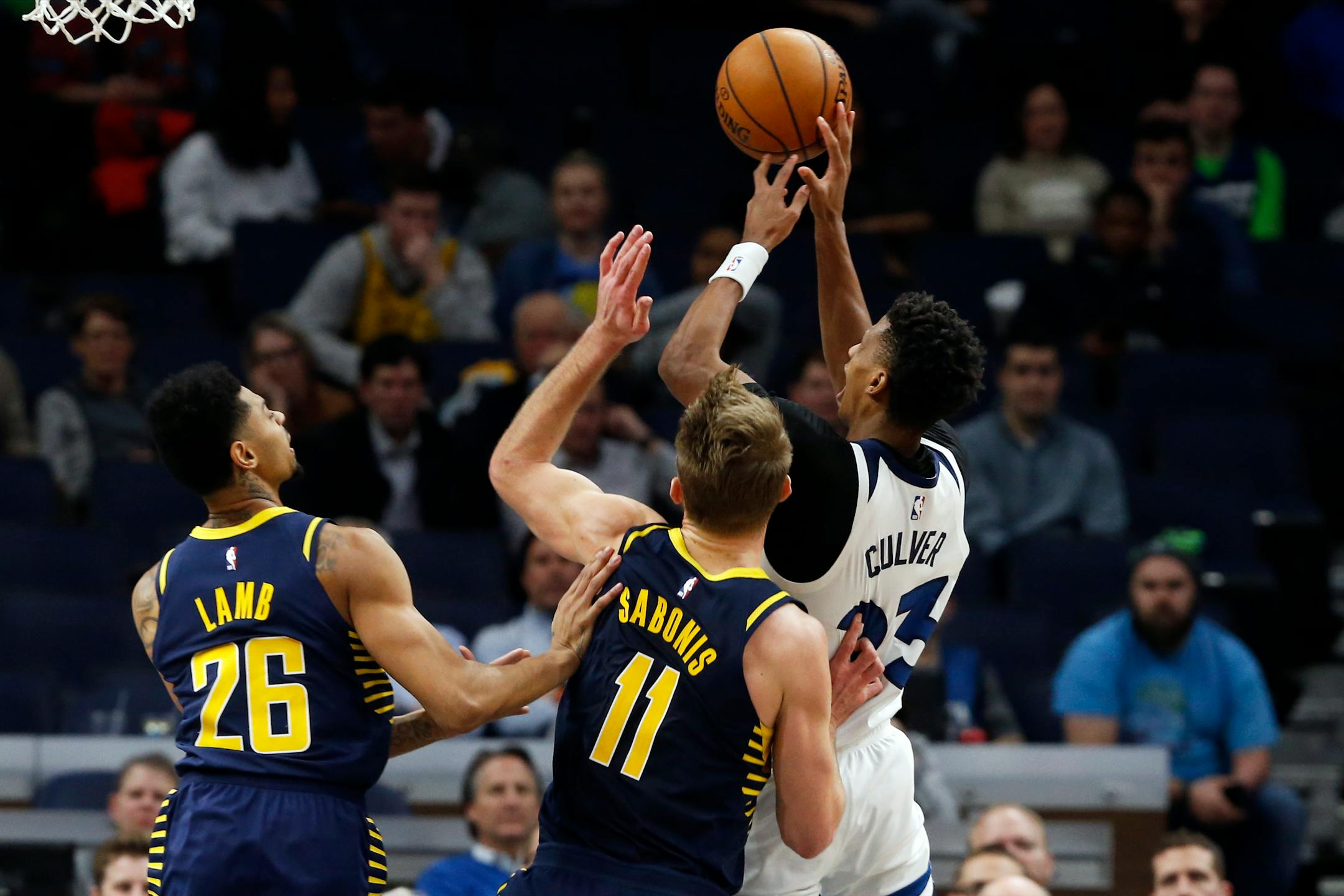 The Timberwolves' Jarrett Culver shoots as the Pacers' Jeremy Lamb, left, and Domantas Sabonis defend.