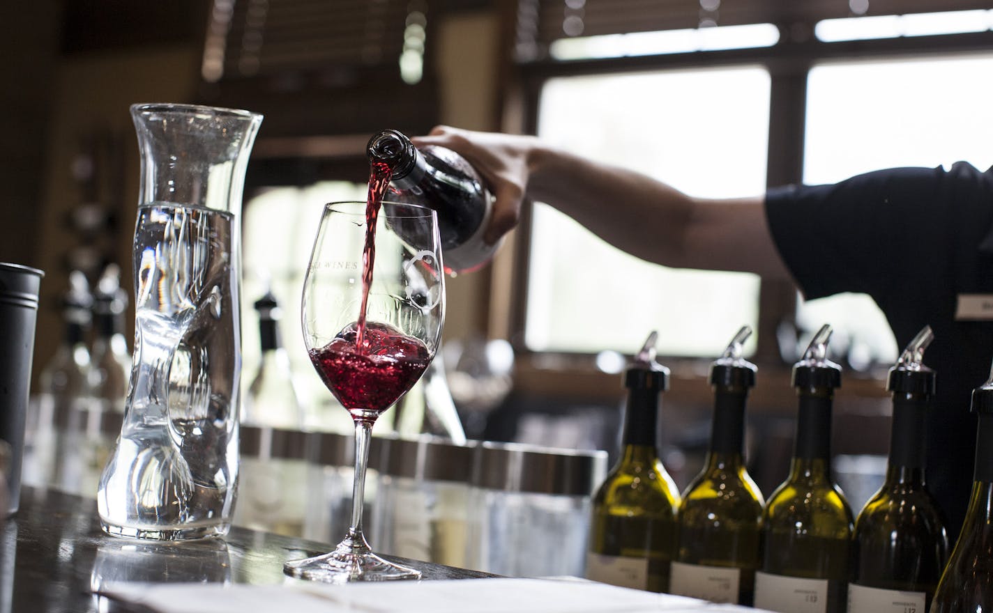 A glass of Marquette Rose is poured for a customer in the tasting room at Chankaska Creek Ranch and Winery in Kasota August 28, 2014. (Courtney Perry/Special to the Star Tribune)