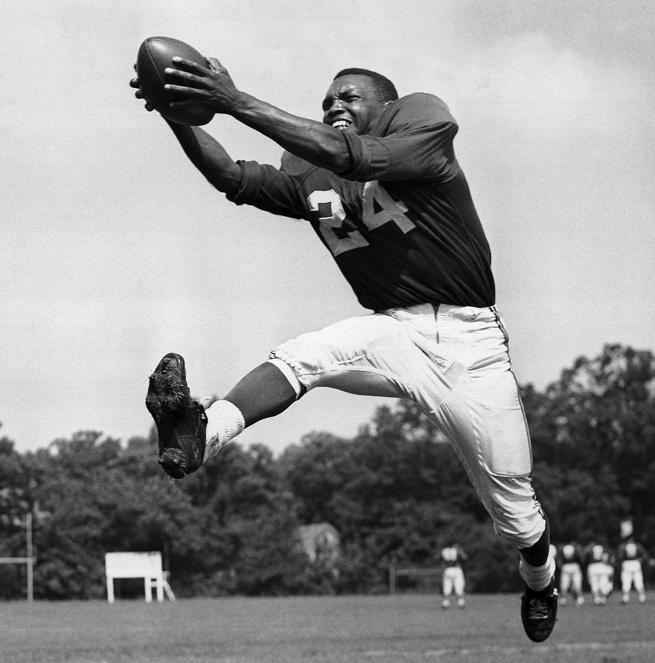 FILE - In this July 30, 1953, file photo, veteran halfback Wally Triplett of Penn State U., originally from La Mott, Pa., poses in action during his second year with Chicago Cardinals and fourth year in the National Football League. Triplett, who left his indelible mark on NFL history by becoming the first African-American player to be drafted and play for an NFL team, passed away Thursday, Nov. 8, 2018, the Detroit Lions announced. He was 92. (AP Photo/File)