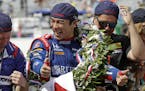 Takuma Sato, of Japan, celebrates on the Yard of Bricks on the start/finish line after winning the Indianapolis 500 auto race at Indianapolis Motor Sp