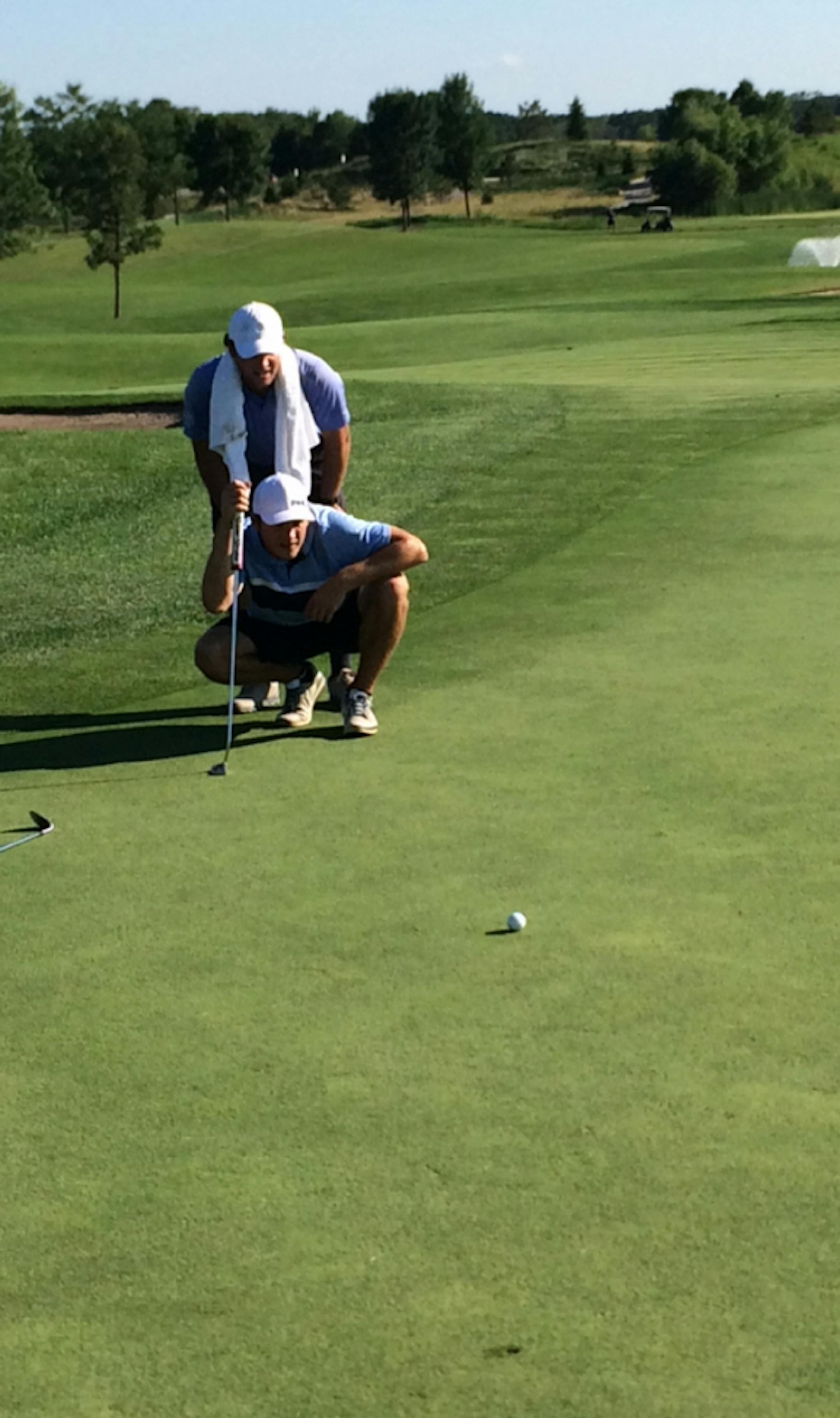 Photo courtesy of A.J. Michaelson A.J. Michaelson, known mostly for his skill on the ice at Mariucci Arena, has found some success on the golf course. The Gophers hockey senior forward is one of 156 Minnesotans that qualified for this week&#xed;s MGA Amateur Championship at Northland Country Club in Duluth. Michaelson, front, is pictured here with his caddie and former University of Minnesota golfer Charlie Branif at a tournament earlier this year at The Meadows at Mystic Lake.