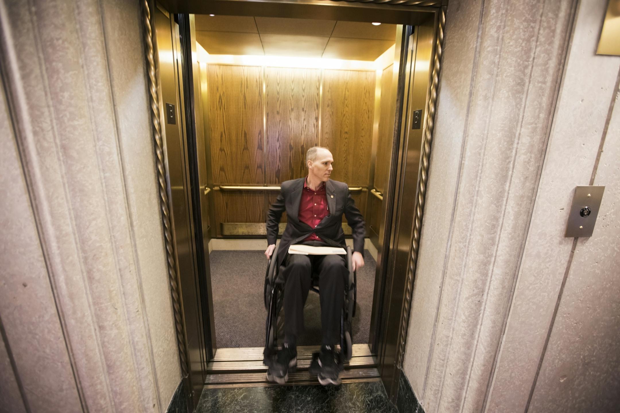 Rep. Rod Hamilton backs into an elevator in the State Office Building.