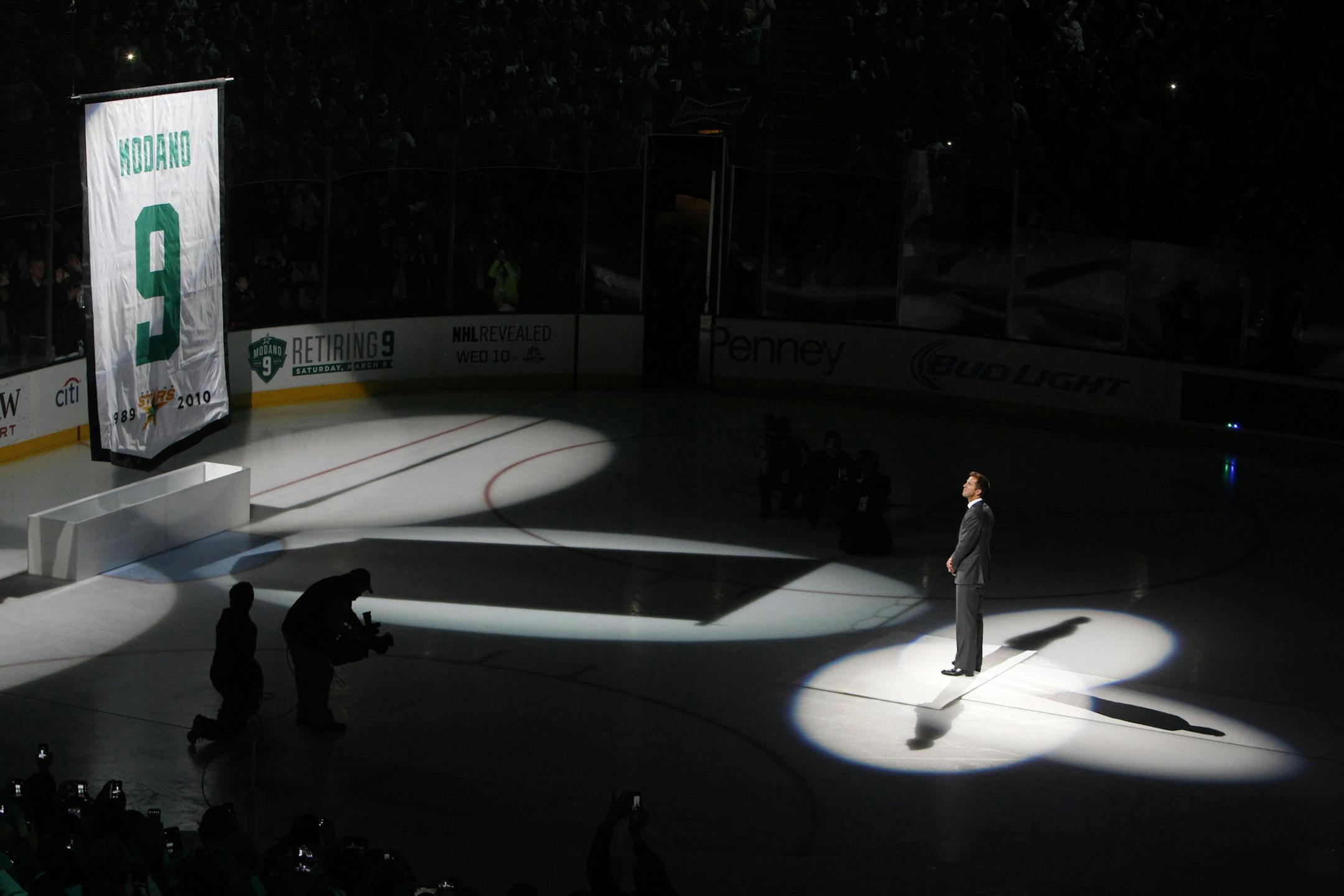 Former Dallas Stars player Mike Modano watches as a banner bearing his jersey number is raised before the Stars' NHL hockey game against the Minnesota Wild, Saturday, March 8, 2014, in Dallas. (AP Photo/ Richard W. Rodriguez)