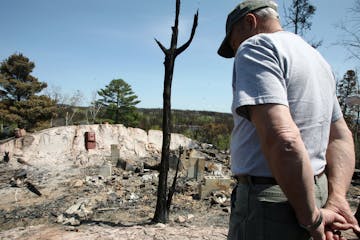 Bruce Kerfoot, owner of the Gunflint Lodge, surveyed the charred remains of a home after the 2007 fire.