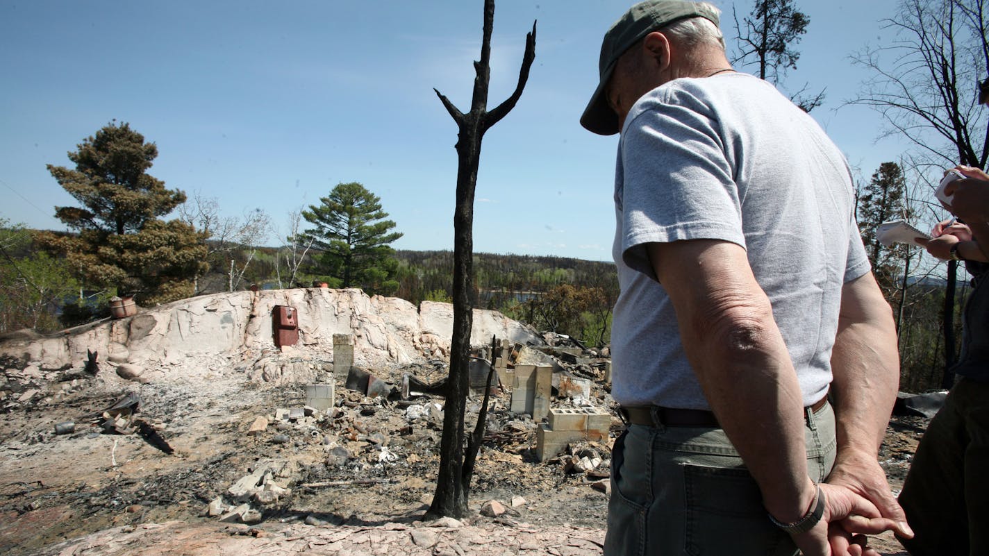 Bruce Kerfoot, owner of the Gunflint Lodge, surveyed the charred remains of a home after the 2007 fire.