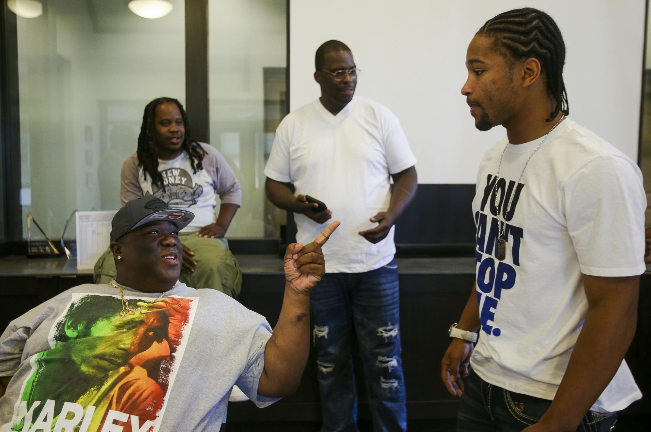 Jerome Brown, left, gives Tyron Jenkins, right, a hard time about the cost of purchasing high-end sneakers.