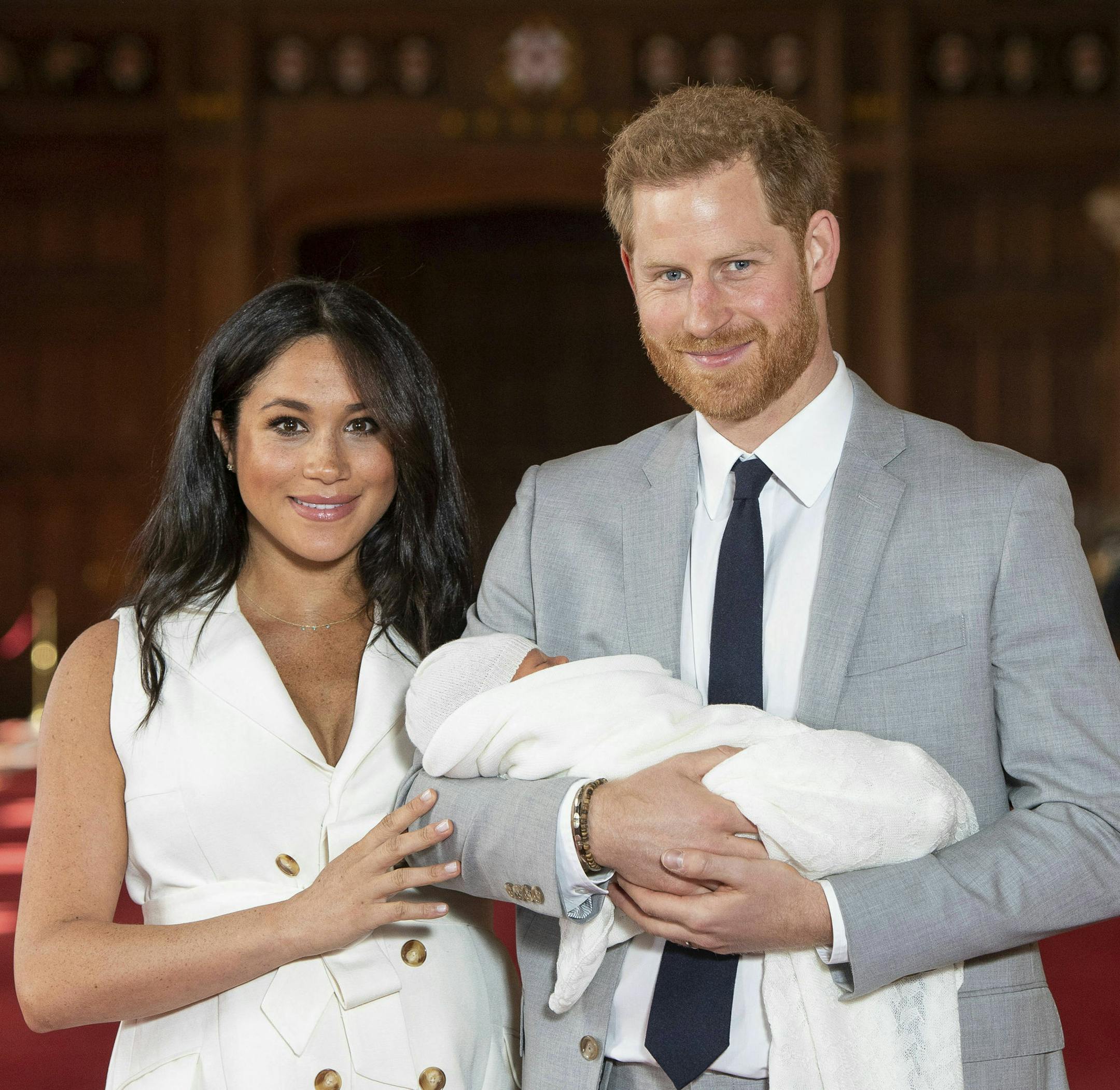 Britain's Prince Harry and Meghan, Duchess of Sussex, during a photocall with their newborn son, in St George's Hall at Windsor Castle, Windsor, south England, Wednesday May 8, 2019. Baby Sussex was born Monday at 5:26 a.m. (0426 GMT; 12:26 a.m. EDT) at an as-yet-undisclosed location. An overjoyed Harry said he and Meghan are "thinking" about names. (Dominic Lipinski/Pool via AP)