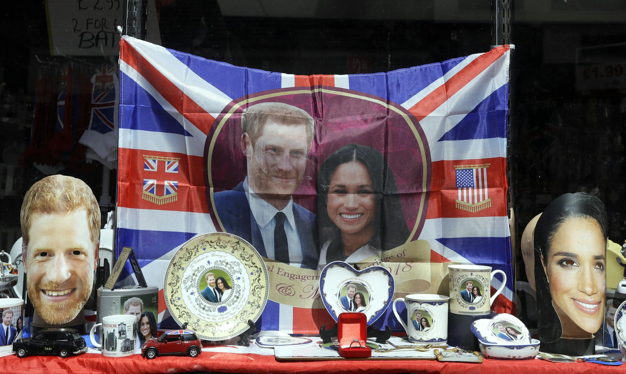 Merchandise is displayed for sale in a shop window in Windsor, England, Monday, May 14, 2018. Preparations are being made in the town ahead of the wedding of Britain's Prince Harry and Meghan Markle that will take place in Windsor on Saturday May 19. (AP Photo/Kirsty Wigglesworth)