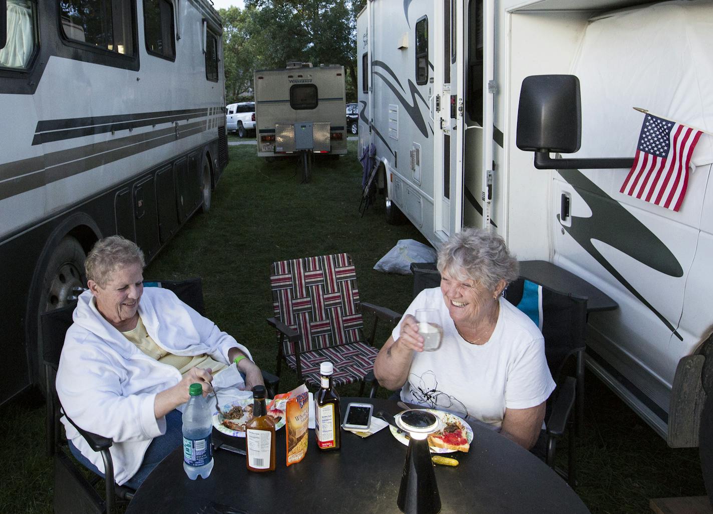 Sisters Lorie Gruenhagen, left, of Howard Lake, and Ruth Baird of Winstead sit outside their RV enjoying their dinner and some wine at the State Fair campground. ] (Leila Navidi/Star Tribune) leila.navidi@startribune.com BACKGROUND INFORMATION: The campground of the Minnesota State Fair on Tuesday, August 30, 2016. When one day at the Minnesota State Fair isn't enough, why not spend every day--and night--at the fair? For some diehard fair lovers, it's a family tradition to enter early every morn