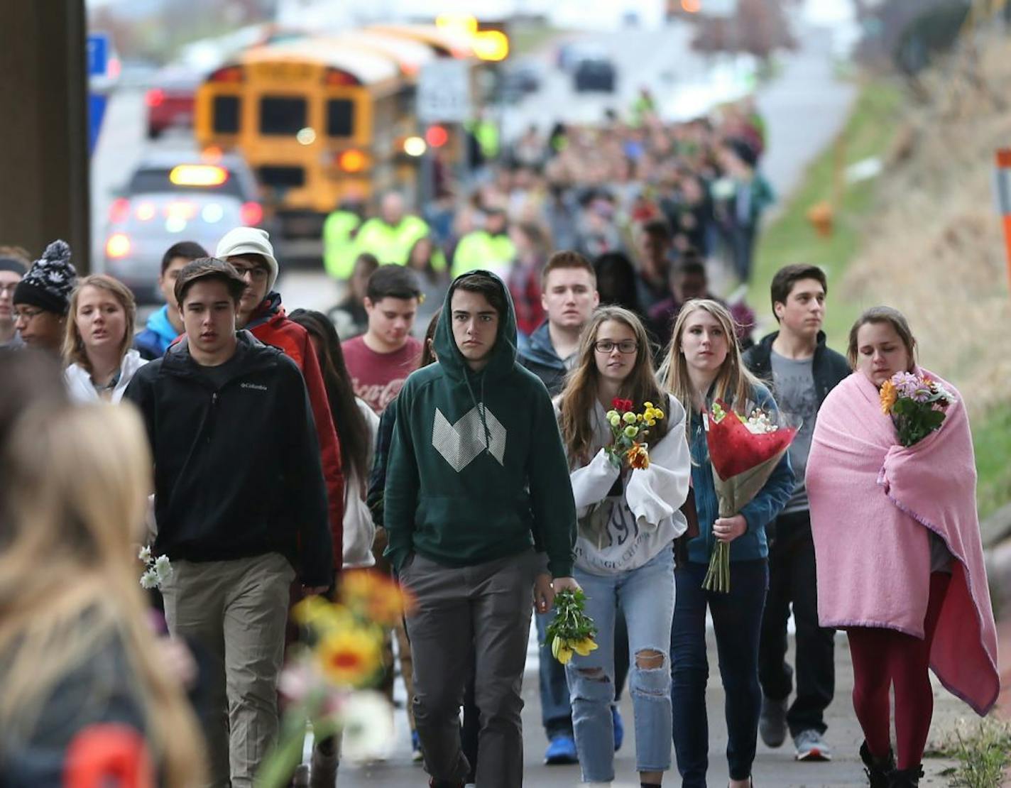 Four bus loads of Students from Mounds View High school gathered at the crash scene along hwy 96 where they left memorials for two students that were killed in a traffic accident December 05,2016 in Mounds View, MN.