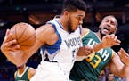Minnesota Timberwolves' Karl-Anthony Towns, left, drives into Utah Jazz's Boris Diaw of France in the second half of an NBA basketball game Monday, No