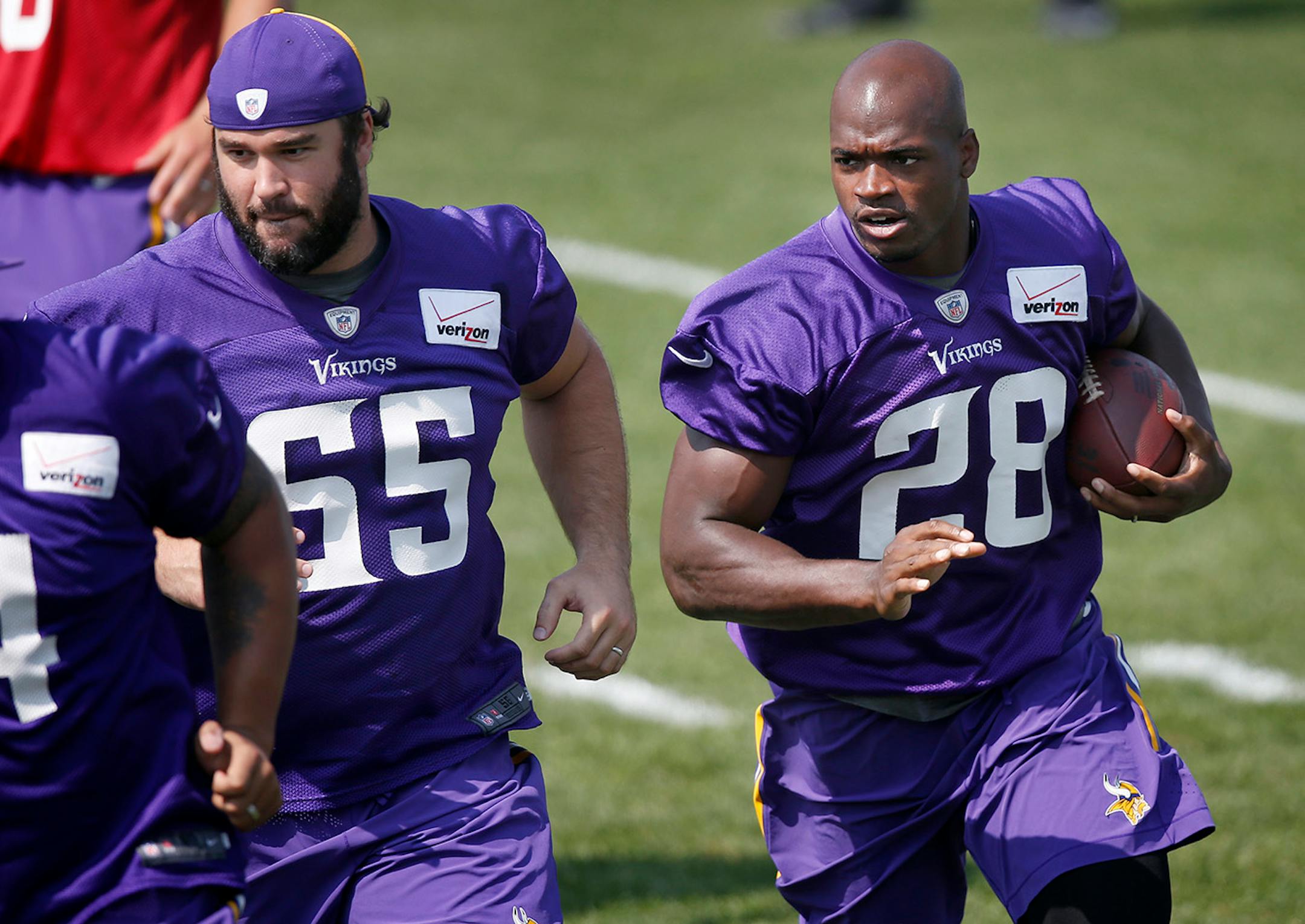 Minnesota Vikings John Sullivan (65) and Adrian Peterson (28) during the morning practice on Saturday. ] CARLOS GONZALEZ cgonzalez@startribune.com - August 2, 2014 , Mankato, Minn., Minnesota State University, Mankato, Minnesota Vikings Training Camp, NFL,