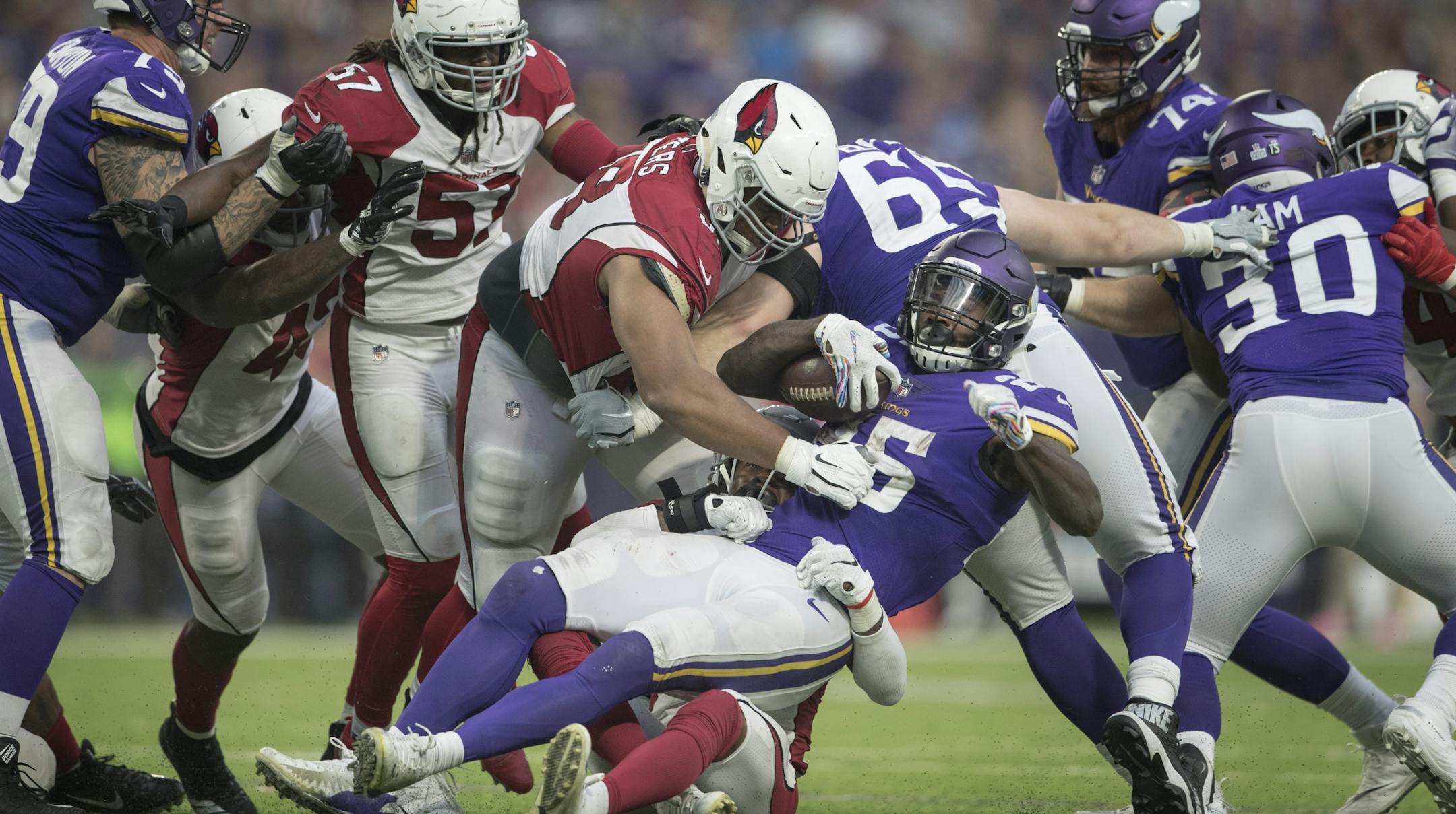 Minnesota Vikings running back Latavius Murray (25) was tackled by Arizona Cardinals strong safety Budda Baker (36) late in the forth quarter at U.S. Bank Stadium Sunday October 14, 2018 in Minneapolis, MN.