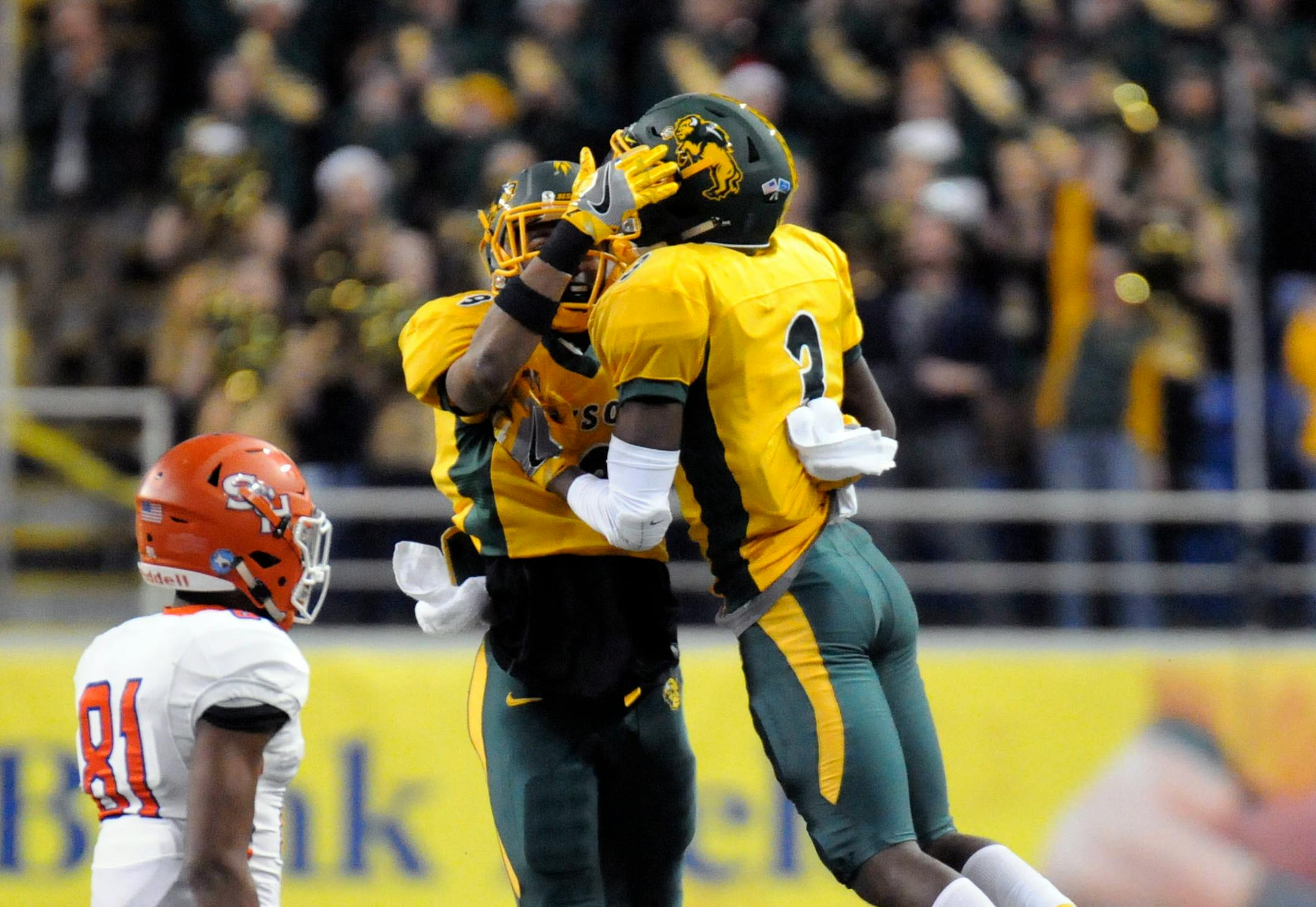 North Dakota State safety Tre Dempsey (3) celebrates with cornerback Marquise Bridges as Sam Houston State receiver Nathan Stewart (81) watches after snaring an interception during an NCAA college football game, Friday, Dec. 15, 2017 in Fargo, N.D. (Gene Schallenberg/The Huntsville Item via AP)