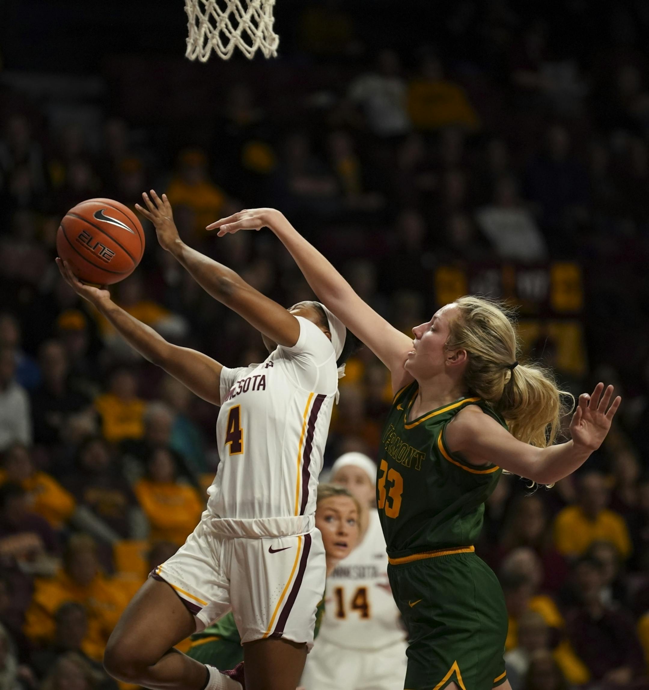 Minnesota Golden Gophers guard Jasmine Powell (4) got a first half shot off while defended by Vermont Catamounts forward Delaney Richason (33). She led the Gophers with 19 points.