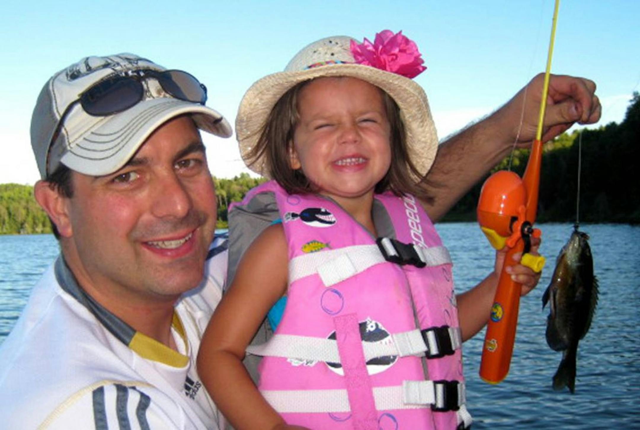 First crappie: Bryn Bartus, 3, of Rogers, was all smiles after catching her first crappie on Sturgeon Lake just north of Hibbing. Dad Matt Bartus didn't mind that it wasn't a trophy catch.