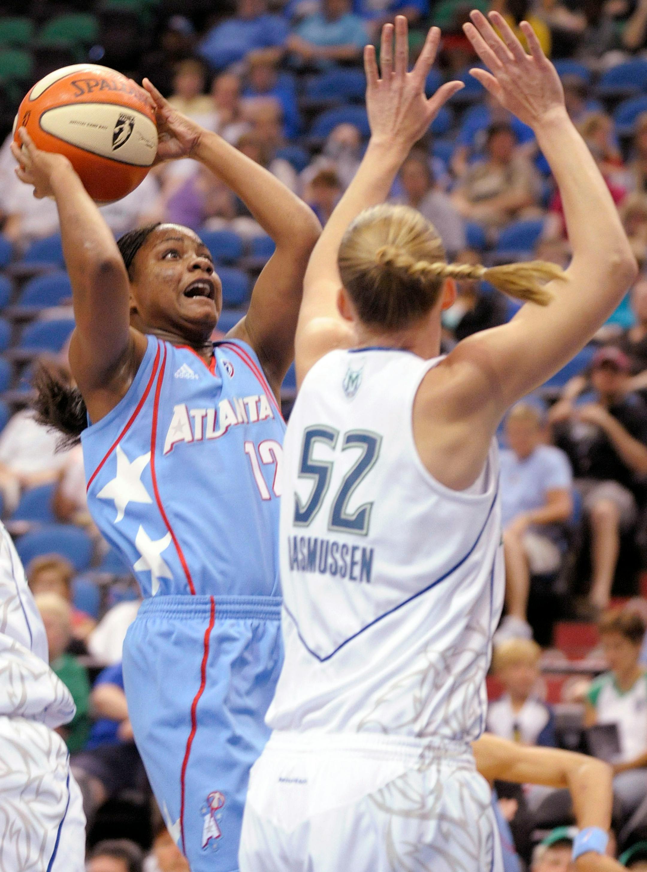 Atlanta Dream's Ivory Latta goes up for a shot against Minnesota Lynx's Kristen Rasmussen during the second quarter of a WNBA basketball game, Wednesday, July 9, 2008 in Minneapolis.