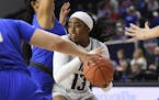 Rice guard Erica Ogwumike (13) fights through the defense of Middle Tennessee forward Jordan Majors, left, in the second half of an NCAA college baske