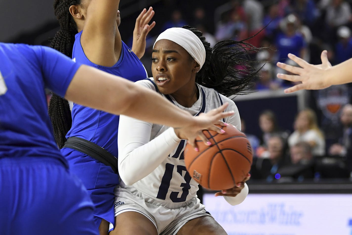 Rice guard Erica Ogwumike (13) fights through the defense of Middle Tennessee forward Jordan Majors, left, in the second half of an NCAA college basketball game in the championship game of the Conference USA women's tournament, Saturday, March 16, 2019, in Frisco, Texas. Rice won 69-54. (AP Photo/Jeffrey McWhorter) ORG XMIT: TXJM116