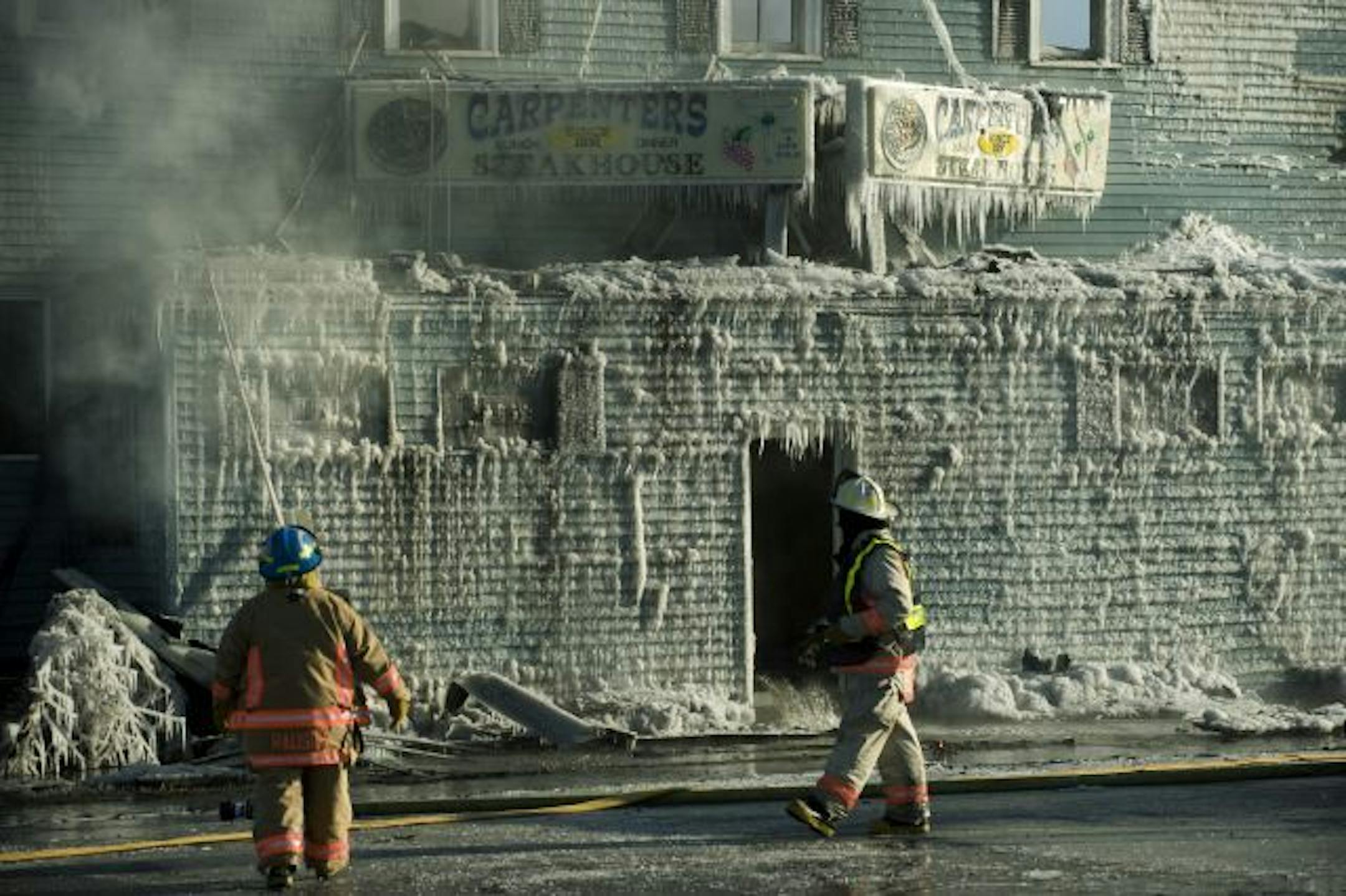 Firefighters put out the last of the flames that destroyed Carpenter's Steak House on Sunday.