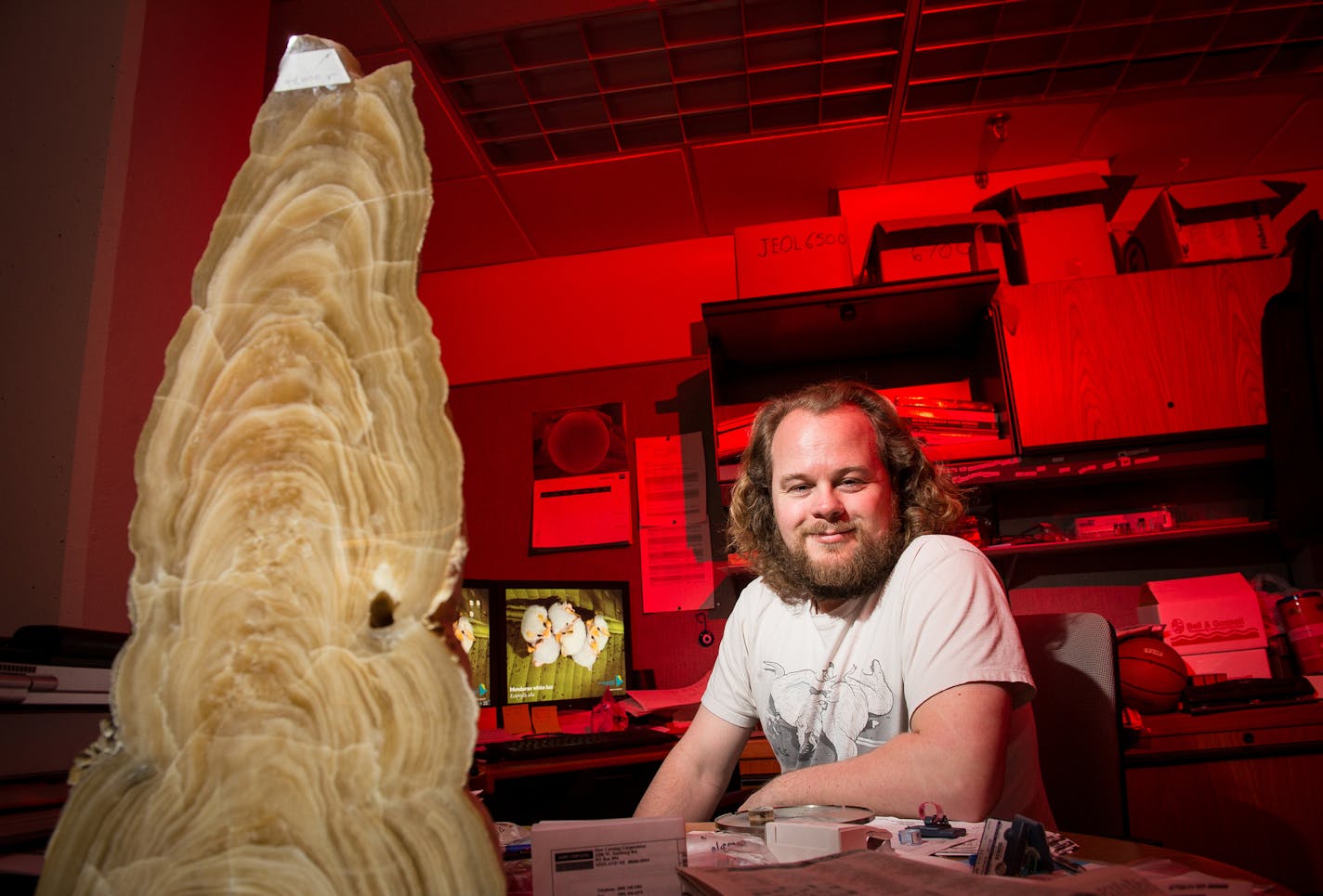 Geologist and caver Nick Seaton was photographed in his office Wednesday afternoon. On the left, an 18,000 year-old stalagmite from Spring Valley Caverns, a cave preserve in Fillmore County, Minnesota. ] (AARON LAVINSKY/STAR TRIBUNE) aaron.lavinsky@startribune.com Glimpse into the caving world with geologist and caver Nick Seaton of the University of Minnesota photographed Wednesday, April 6, 2016 at the Shepard Labs building at the University of Minnesota in Minneapolis.