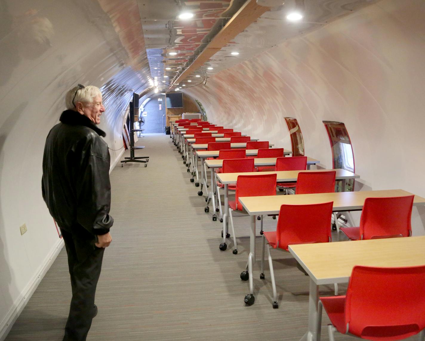 Crews of volunteers and students of the construction trades are working to transform a hangar at the downtown St. Paul airport into a year-round classroom, part of the Learning Jet, a jet and hangar donated to help spark an interest in students, youth groups and scouts who visit as a classroom. Here, Steve Hurvitz, who has spear headed the Learning Jet venture, tours the inside of 727-200, donated by Fed Ex and converted into a classroom Tuesday, Oct. 31, 2017, at Holman Field in St. Paul, MN.]